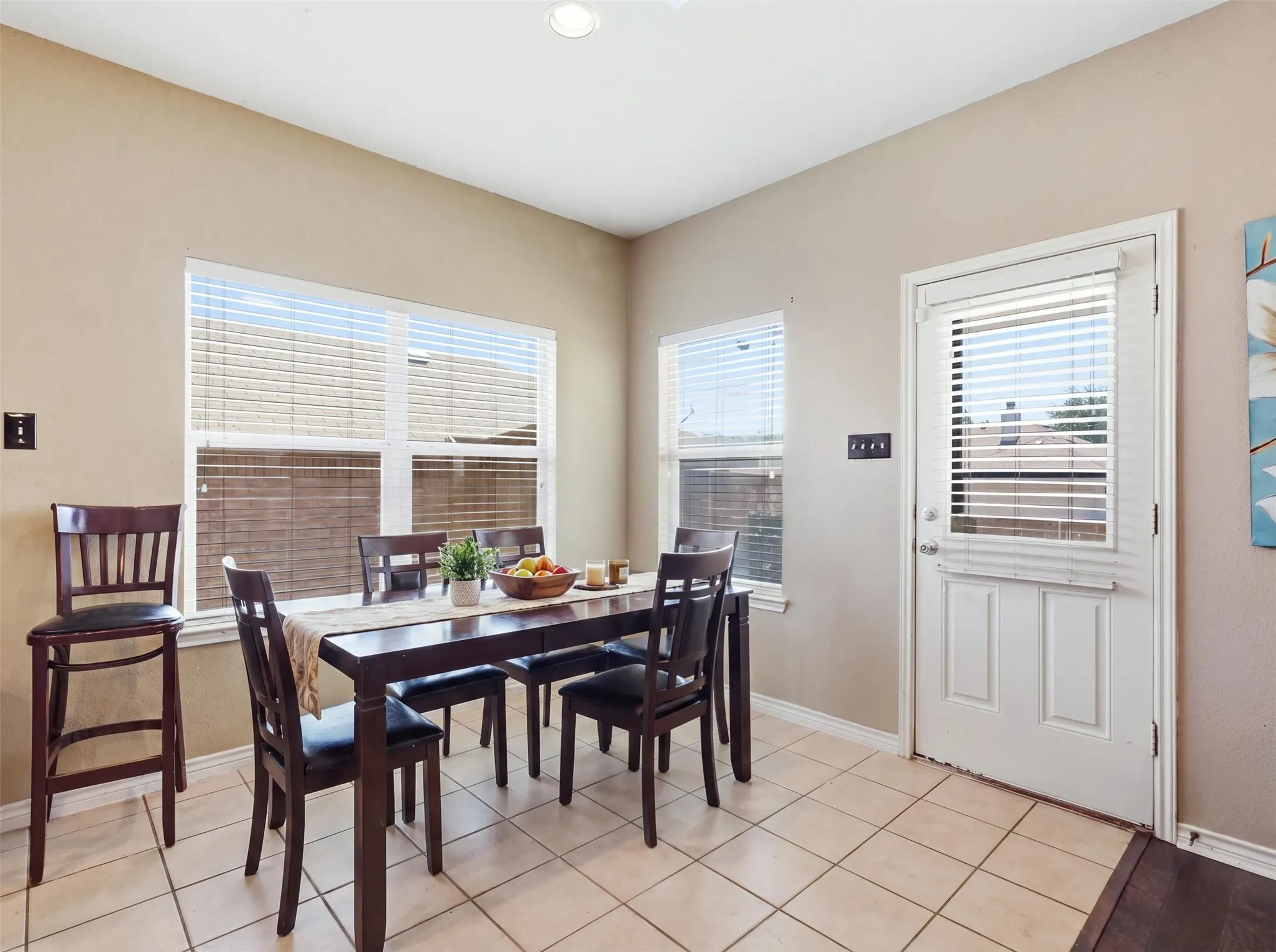 Neutral-toned walls complement the tile flooring