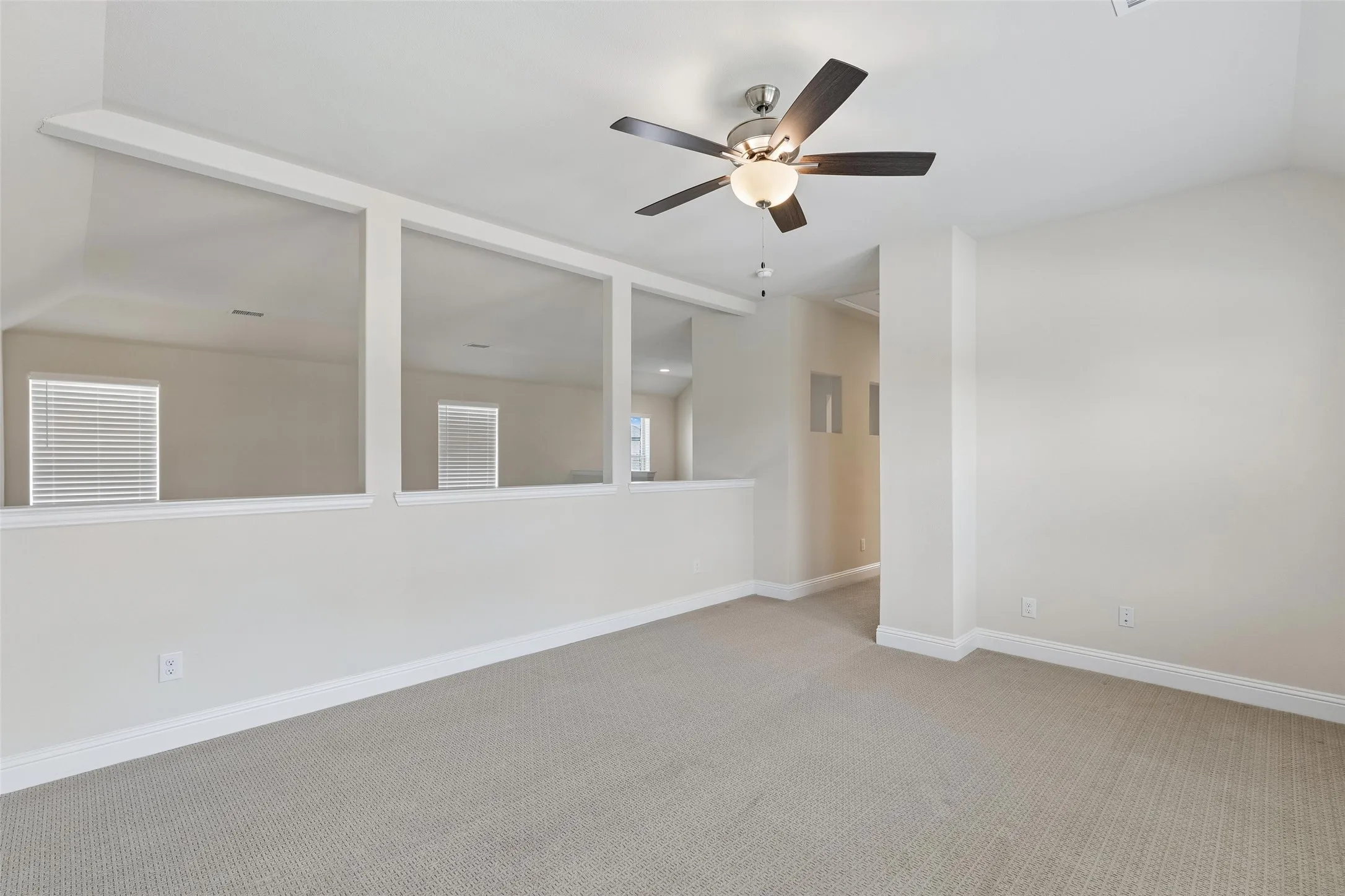 Game room or second living room upstairs. Featuring a ceiling fan, carpet and natural light.