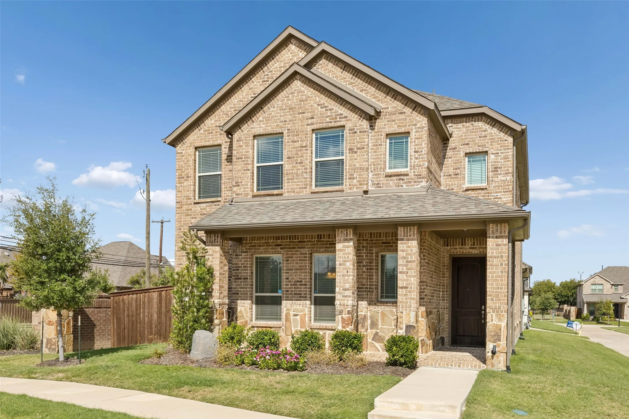 Front of home featuring a beautiful landscaped front yard and view of the alley. No neighbors to the right or left of the home.