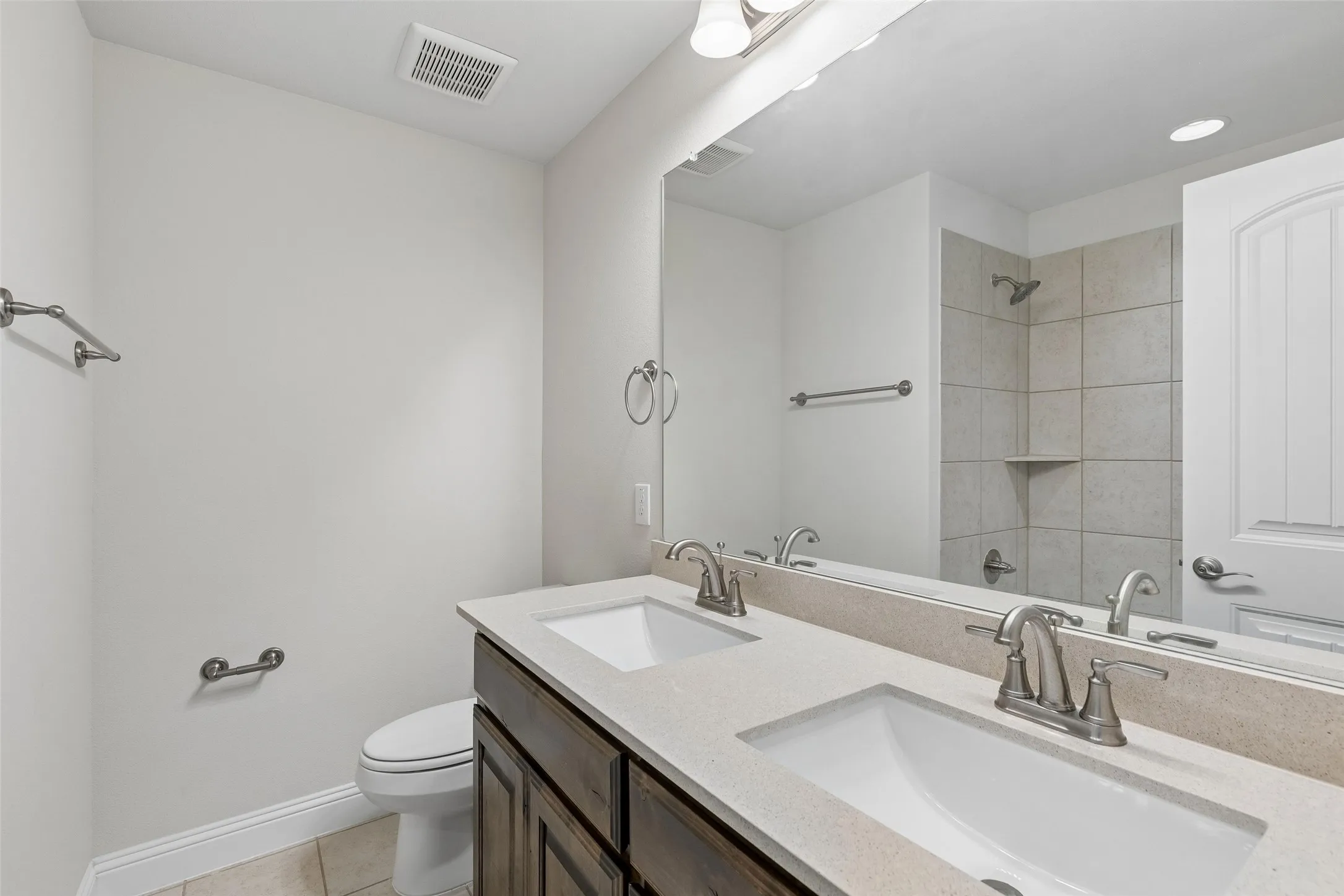 Level 2, full bathroom featuring tile flooring, double sink and bathtub/shower combo.