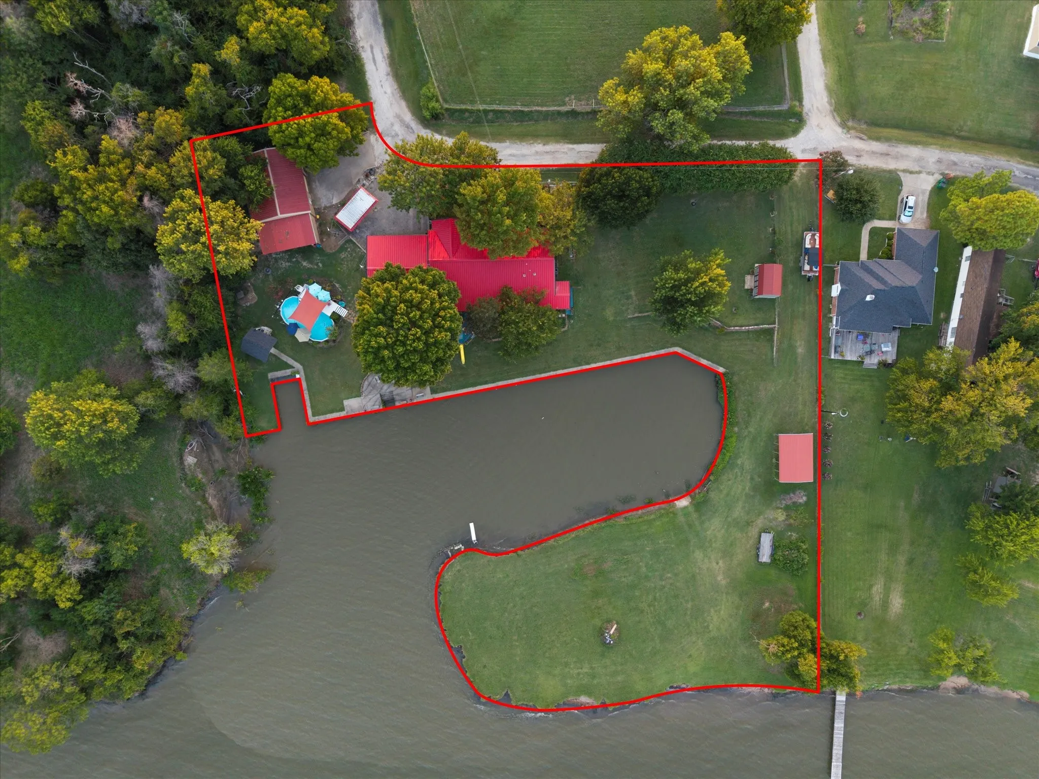 Expansive waterfront property featuring a dedicated dock, private pond, and large grassy areas