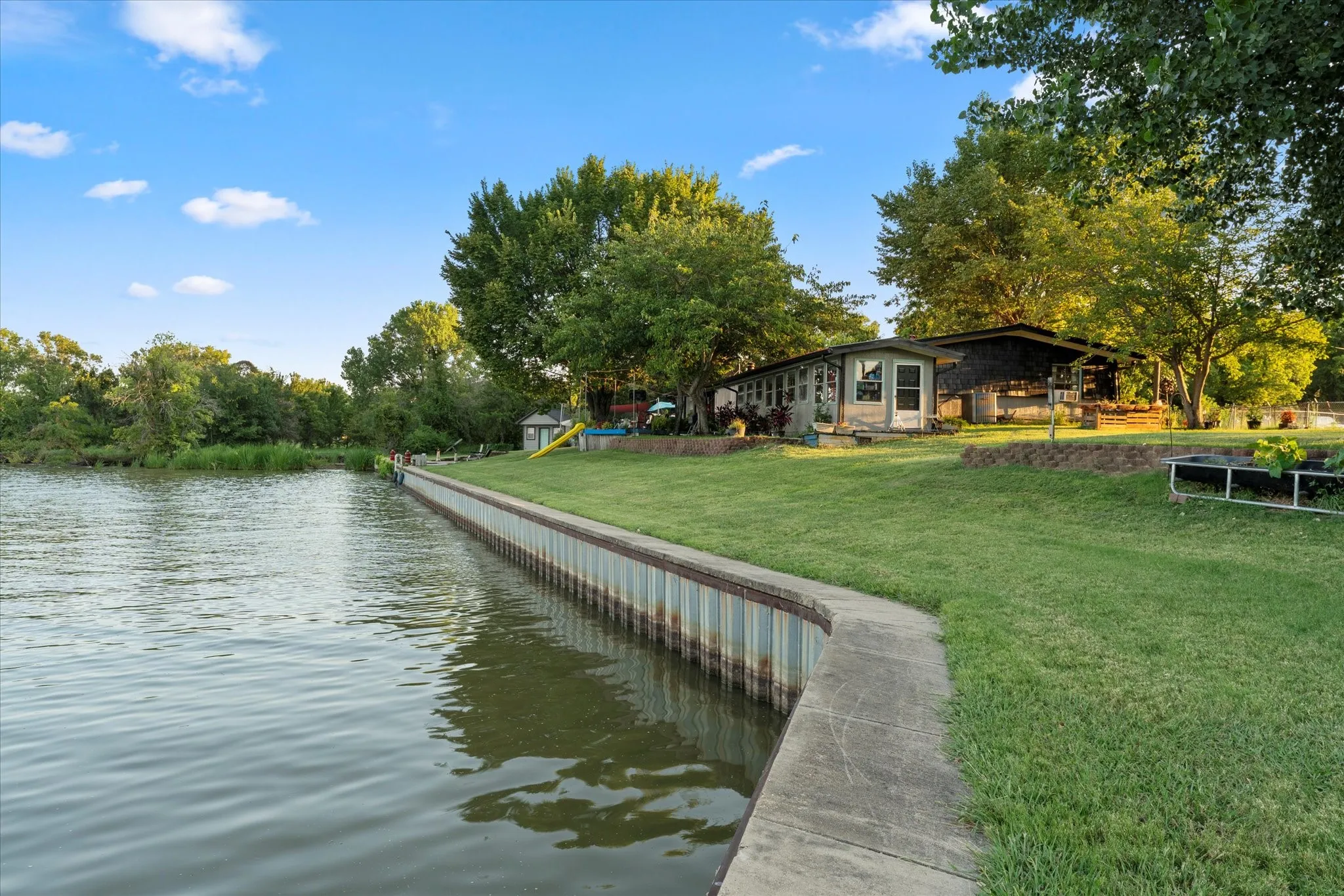 Expansive waterfront property with a concrete retaining wall and sheet pile bulkhead