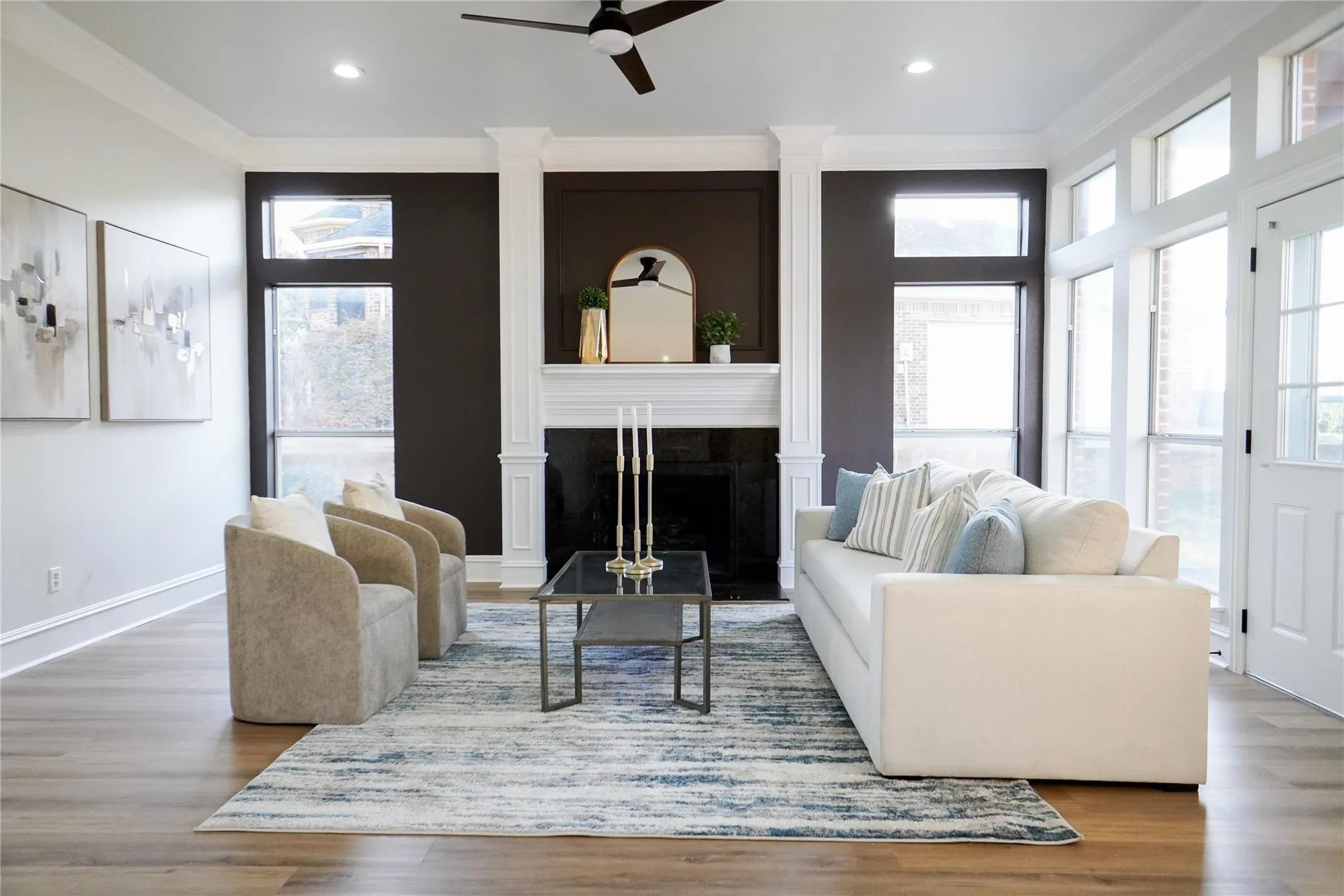 Living room with fireplace & extensive millwork - virtually staged