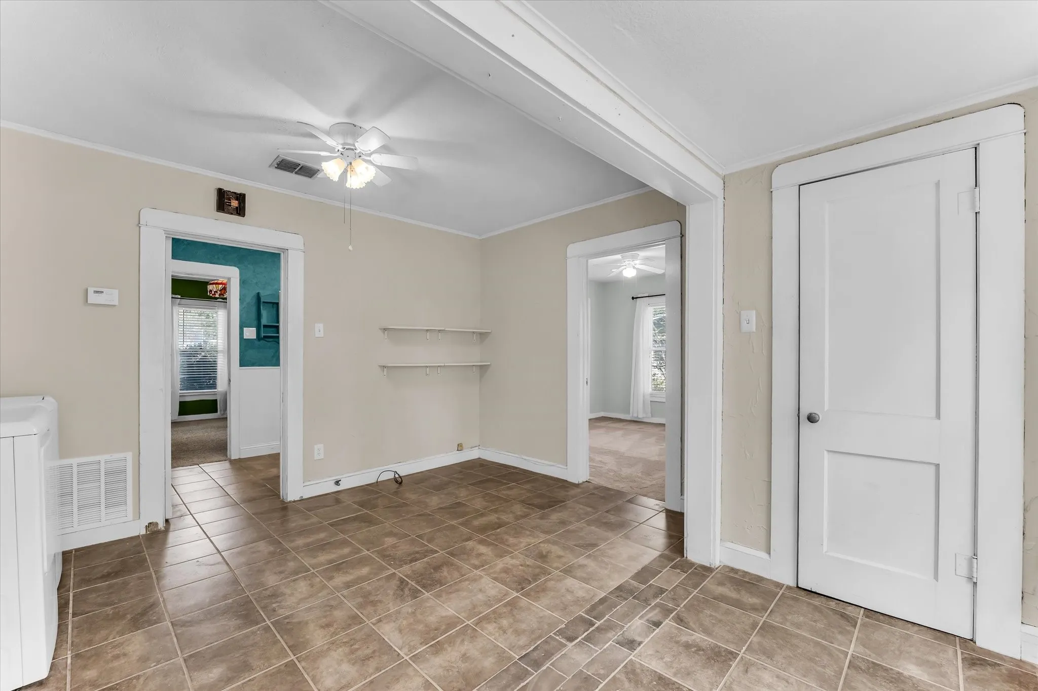 Tiled flooring with neutral wall tones and white trim