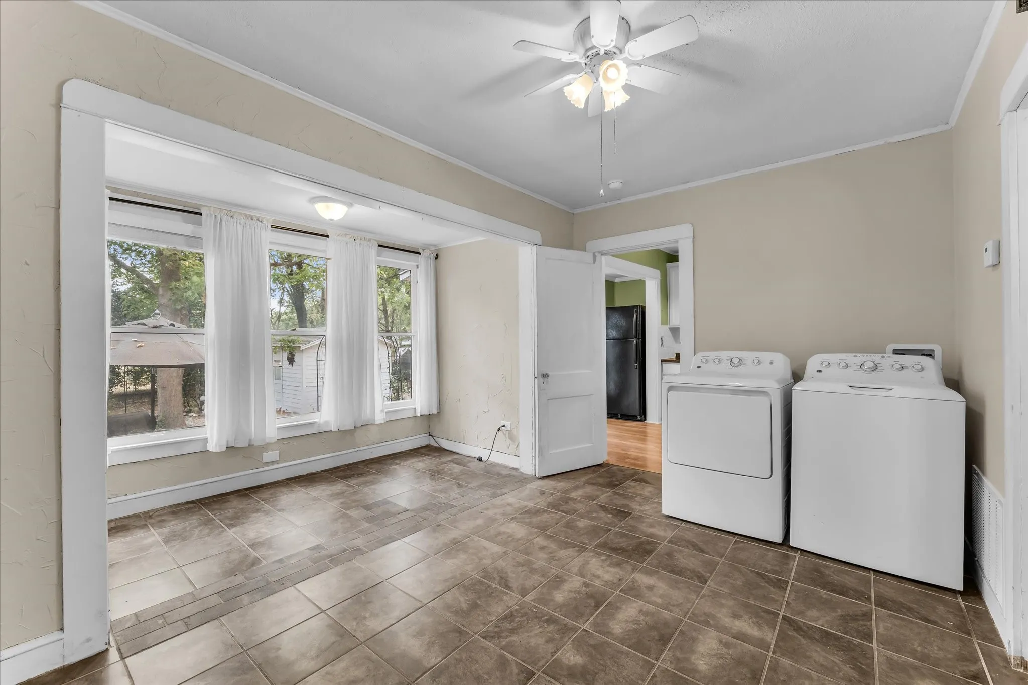 Tile flooring throughout, with a ceiling fan light fixture