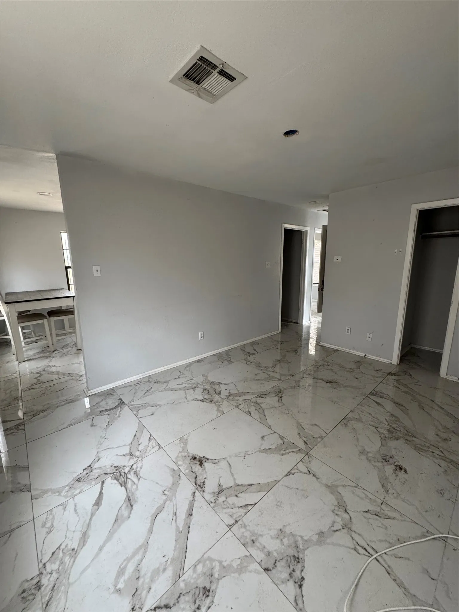 Glossy tile flooring with veined detailing throughout