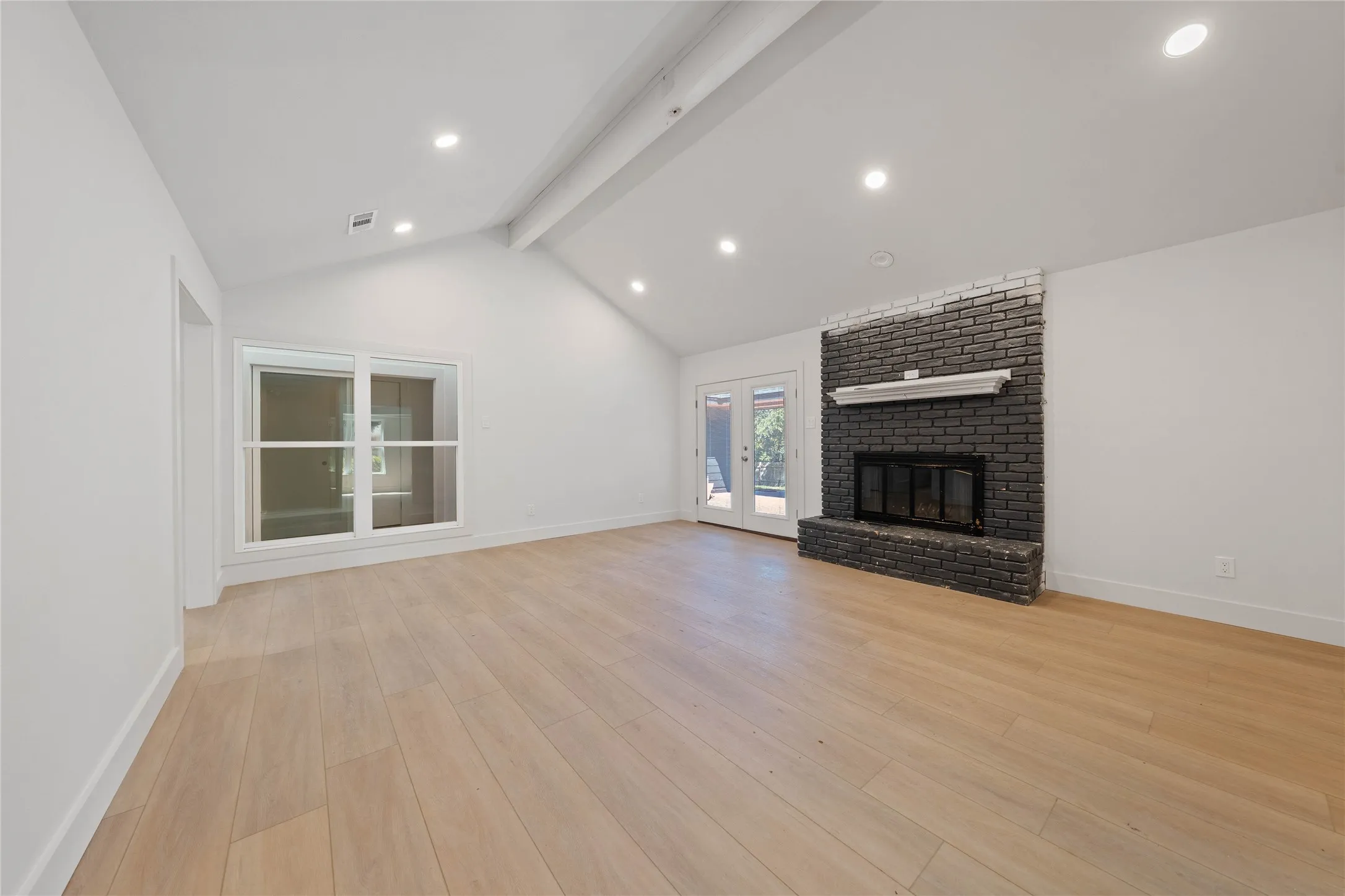 Installed soon: a custom fireplace, light fixtures, and natural wooden ceiling beam