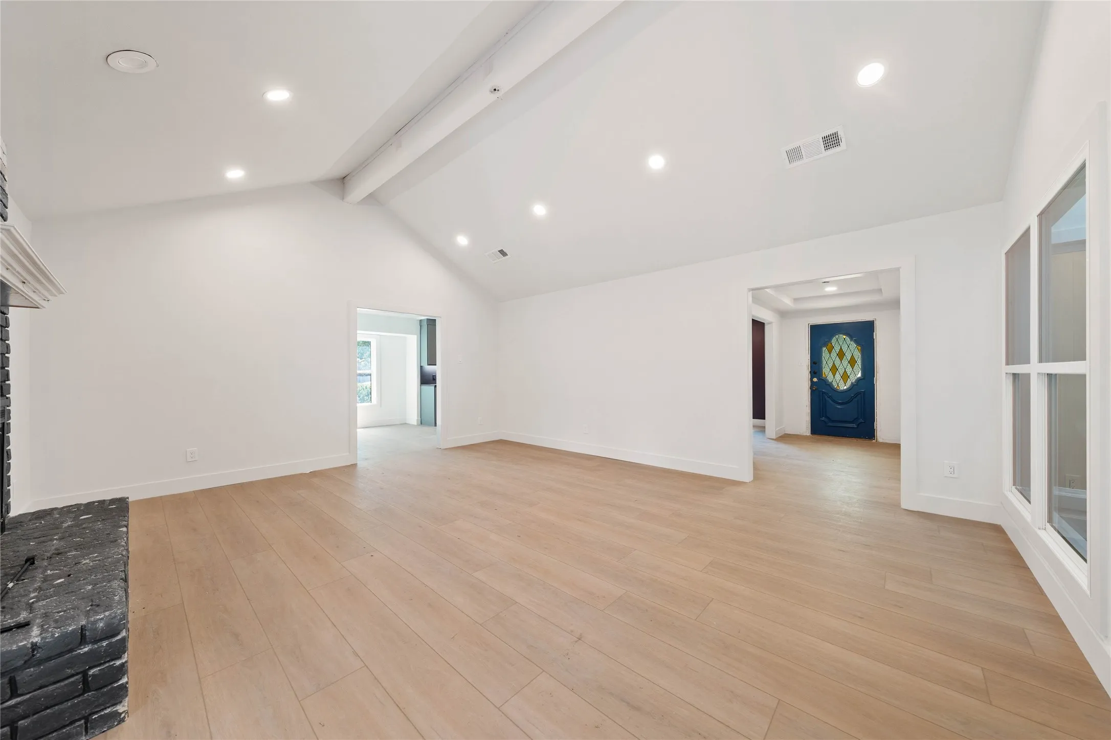 Installed soon: a custom fireplace, light fixtures, and natural wooden ceiling beam