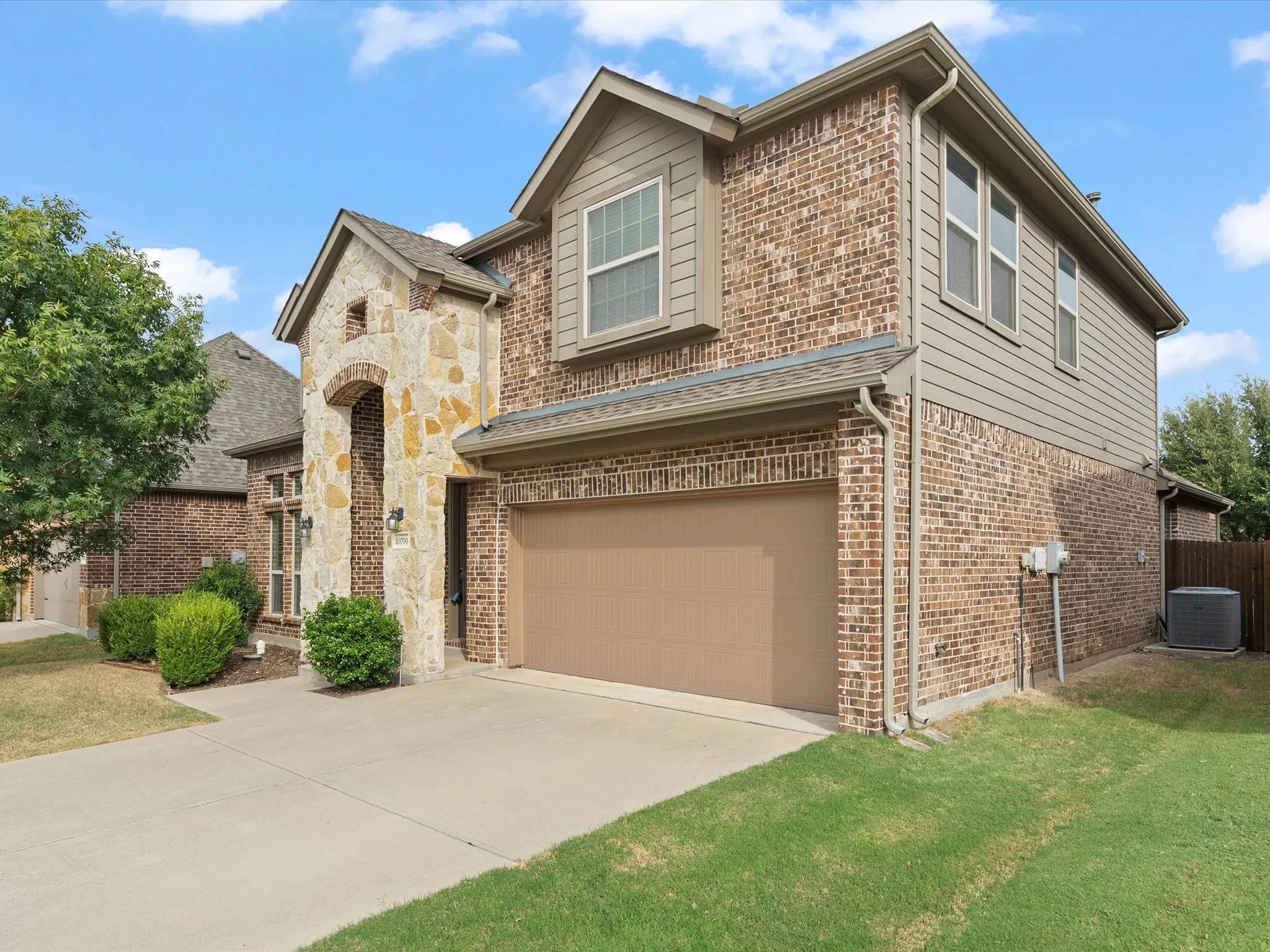 Brick and stone exterior with horizontal siding accents