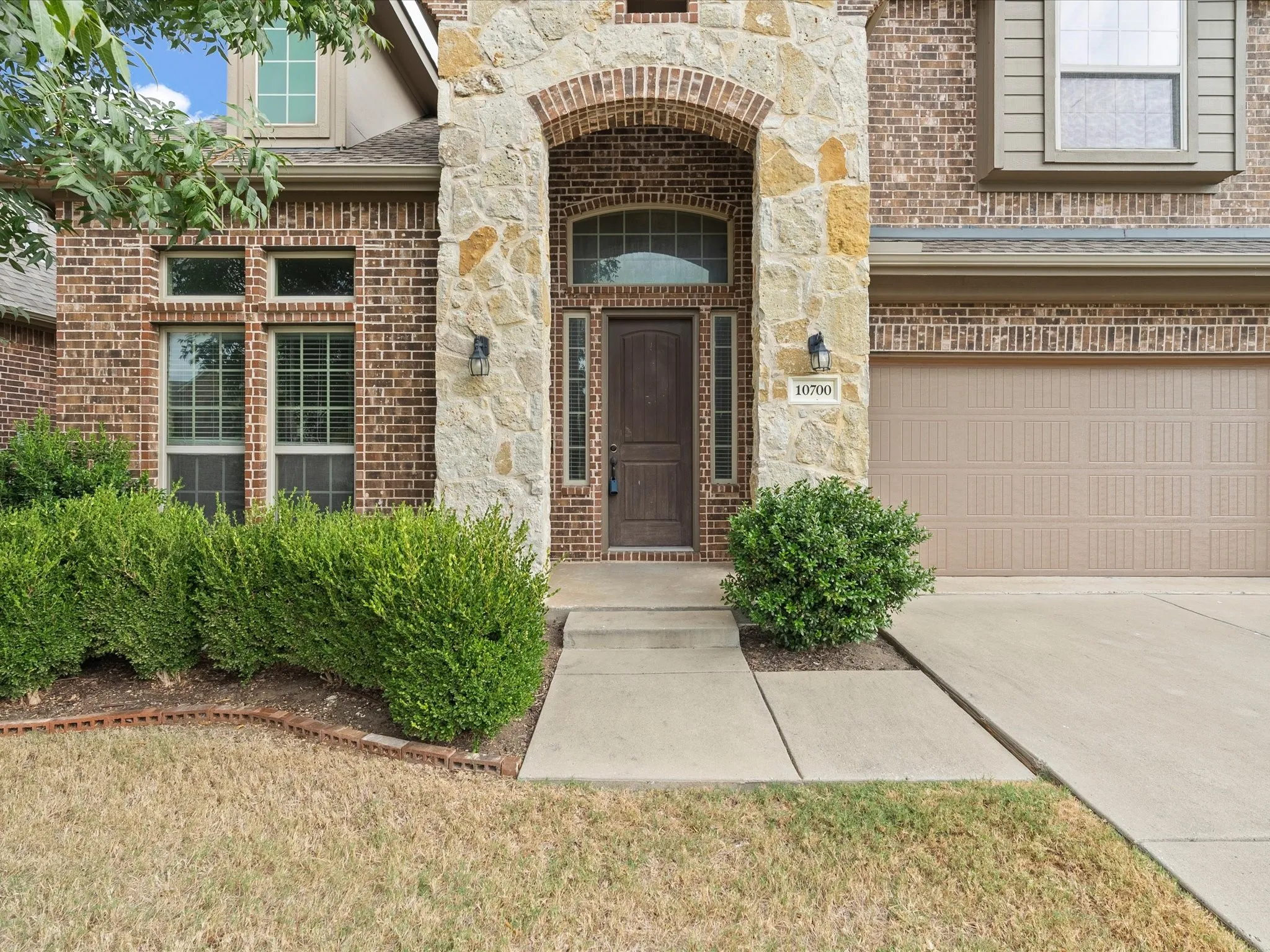 Brick and stone exterior with an arched entry