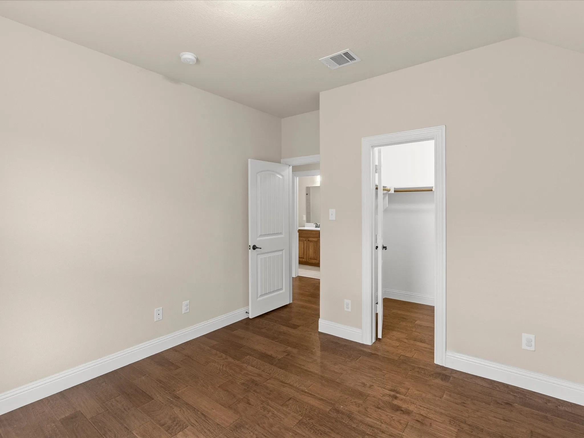 Hardwood-style flooring extends through the space