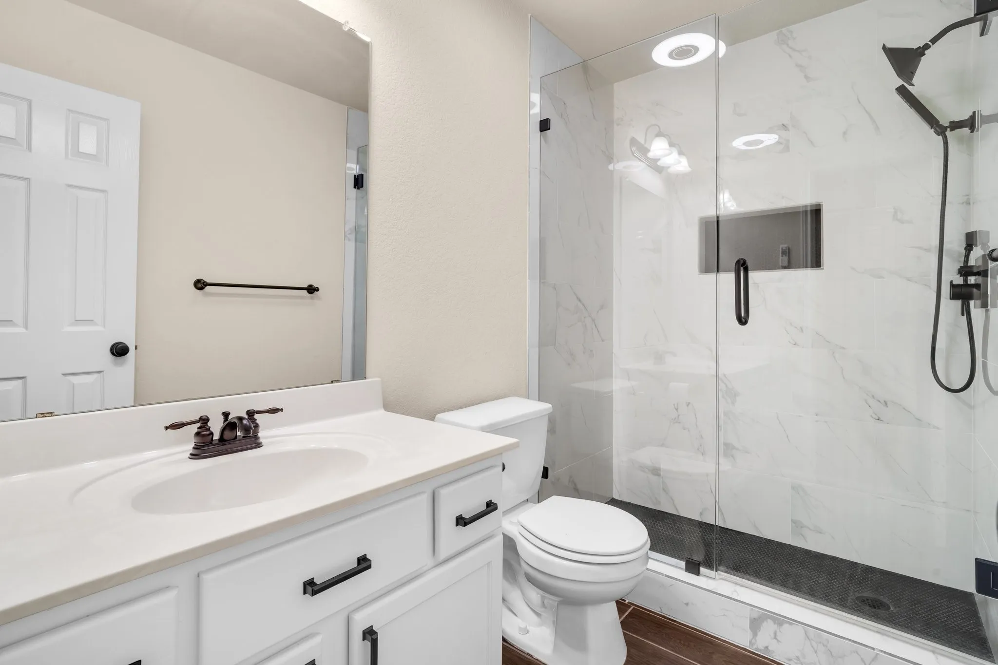 White vanity with an integrated sink and bronze-finish faucet