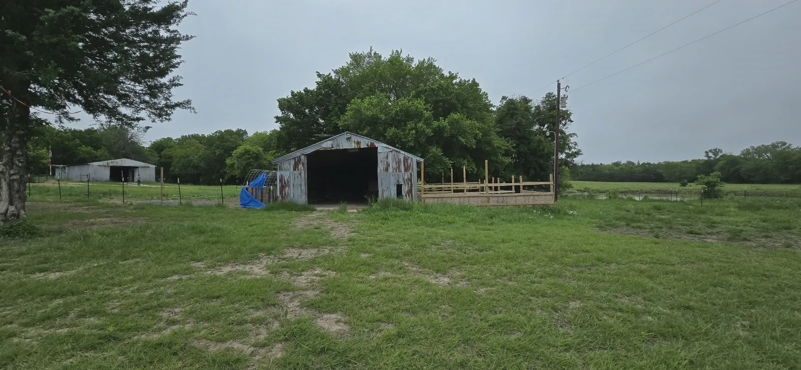 Multiple metal-sided barn structures with open bays