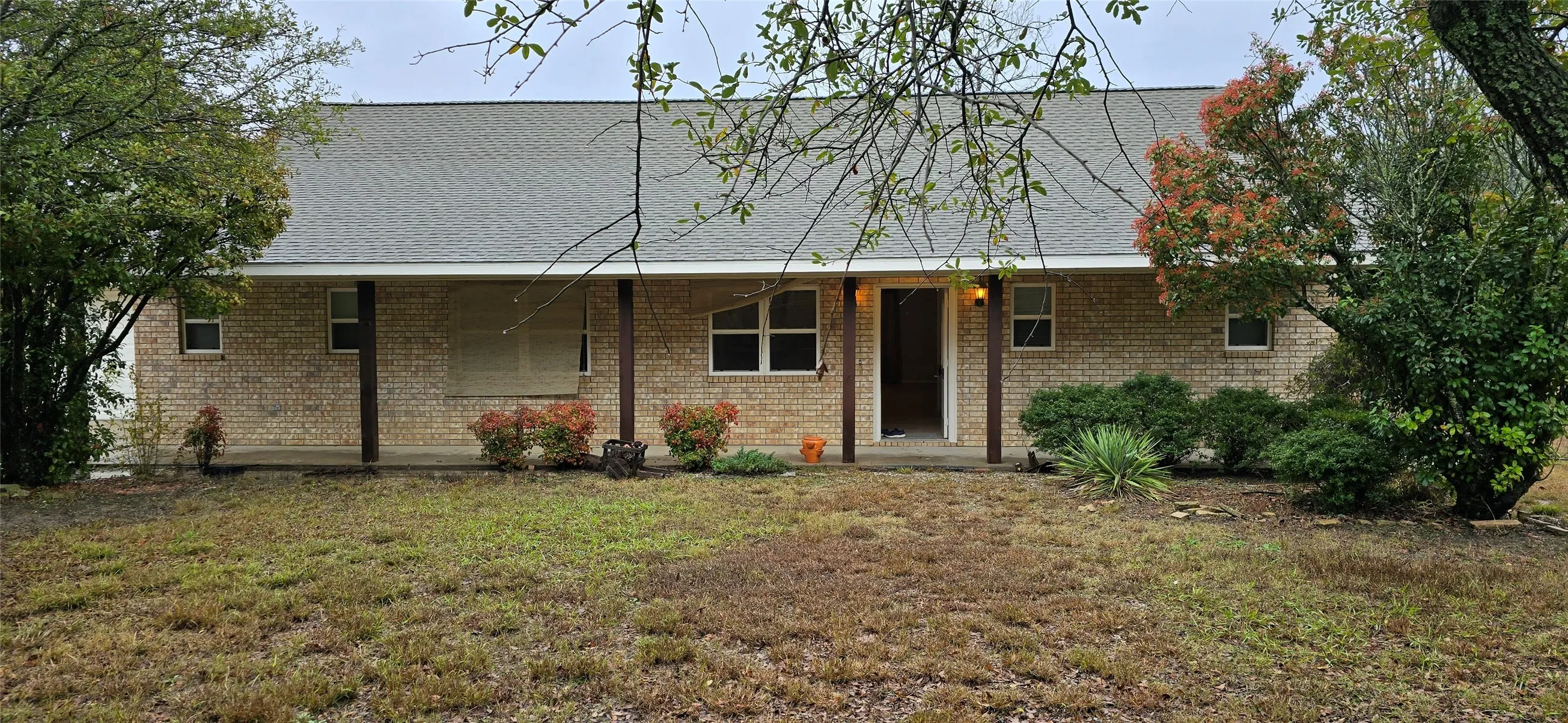 Brick exterior with a gabled roof and covered front porch
