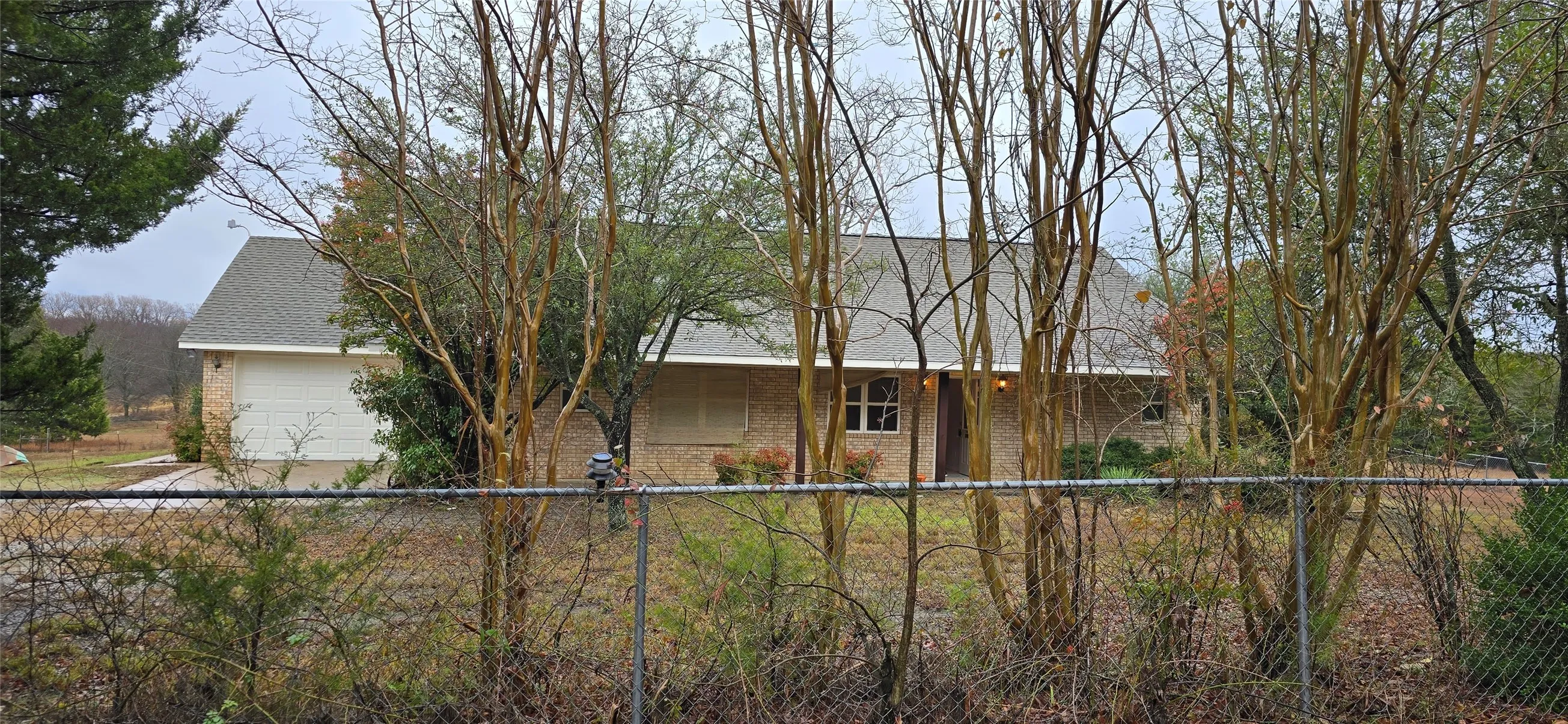 Brick-clad exterior with a prominent front door and attached garage