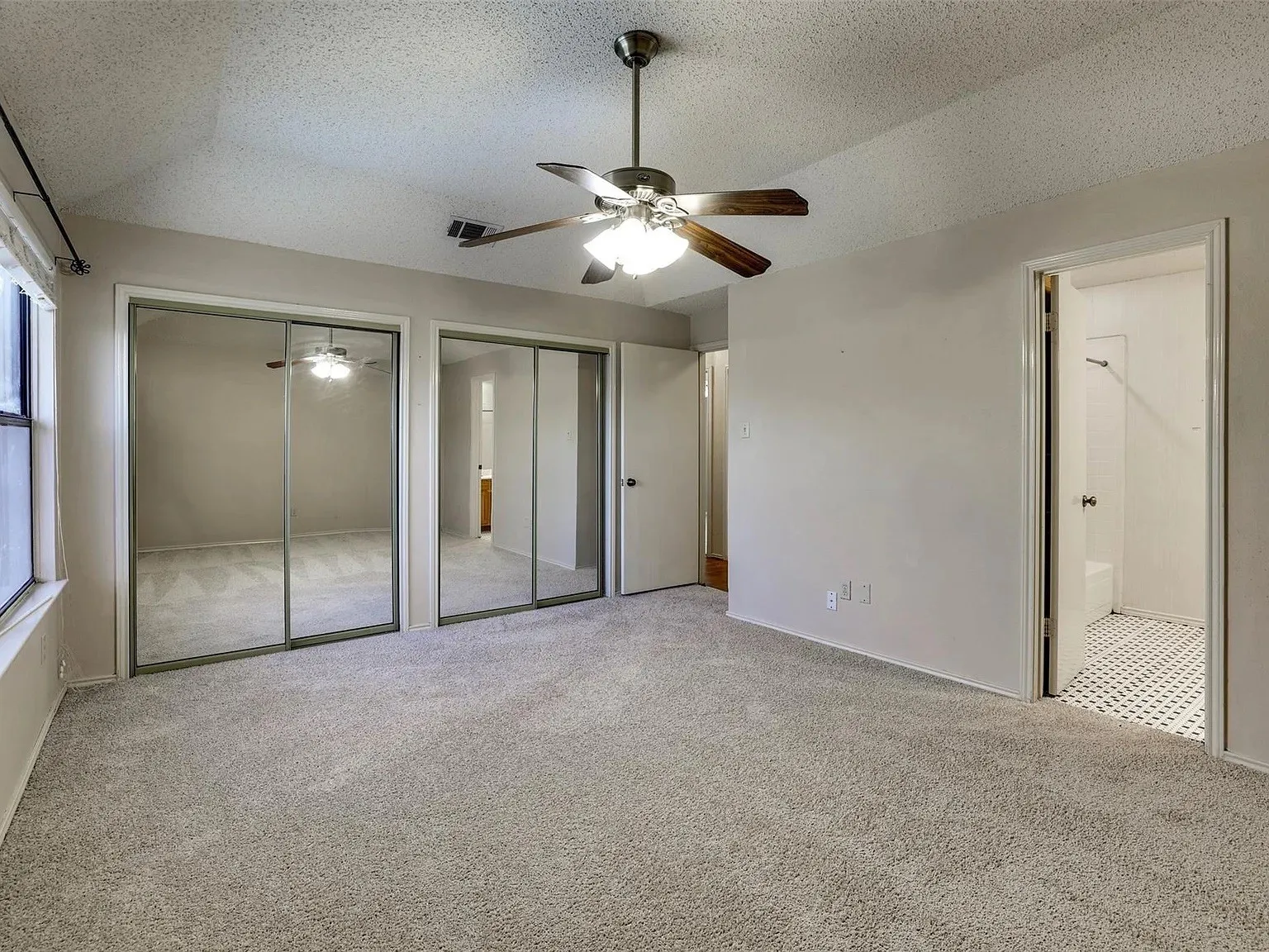 Neutral-toned carpeting throughout the room