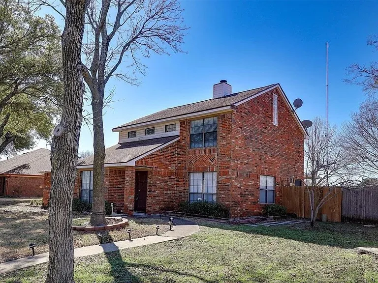 Brick exterior with a gabled roof and white trim