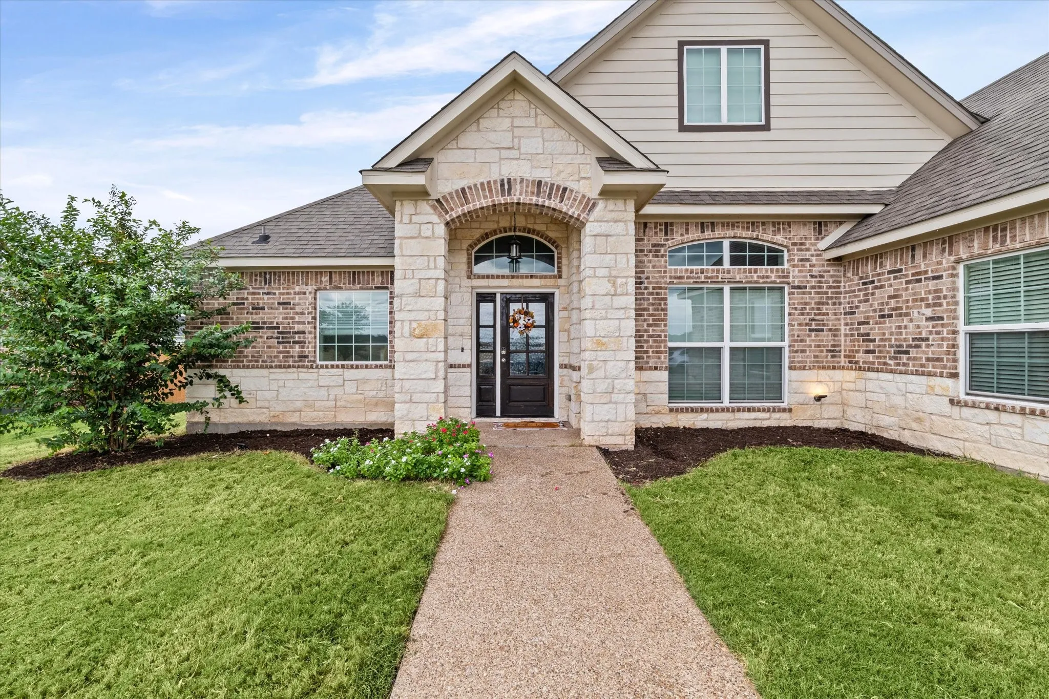 Brick and stone exterior with arched entryway