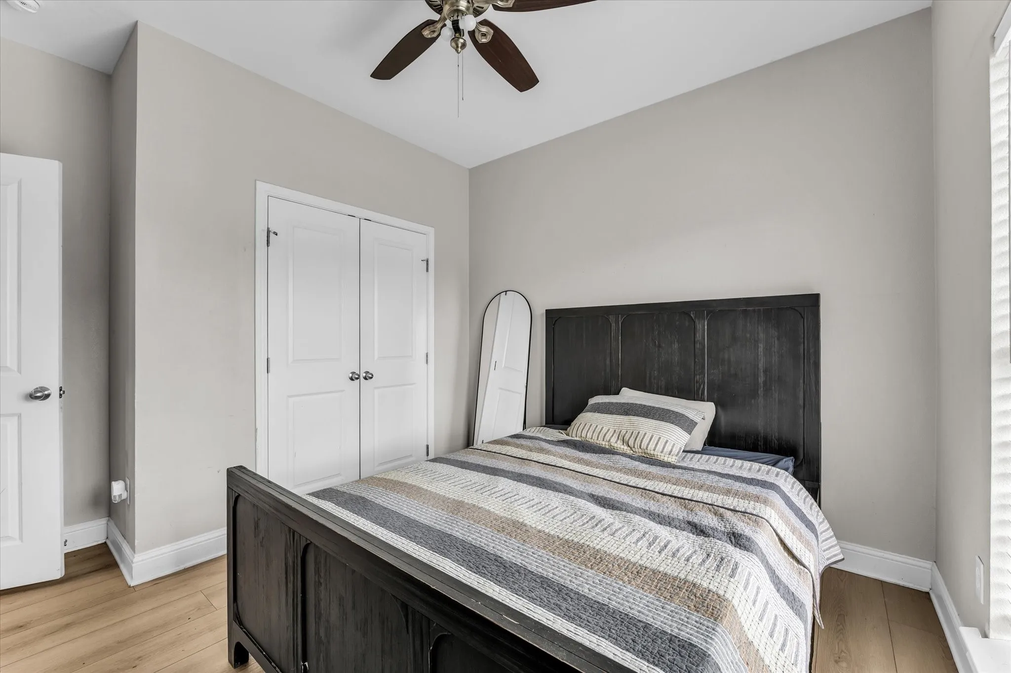Hardwood-style flooring throughout with a ceiling fan