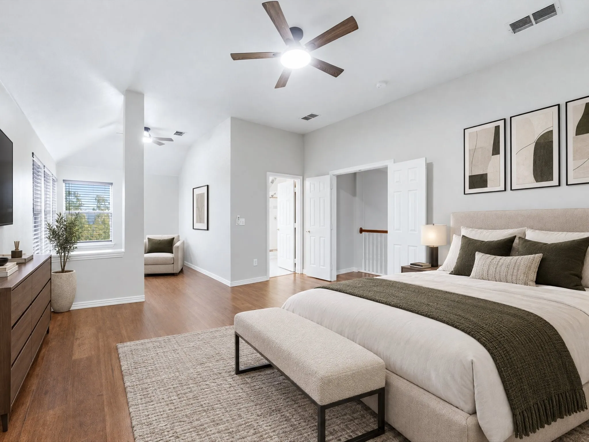 Vaulted ceilings, wood-finish flooring, ceiling fan with integrated lighting, and multiple windows with blinds