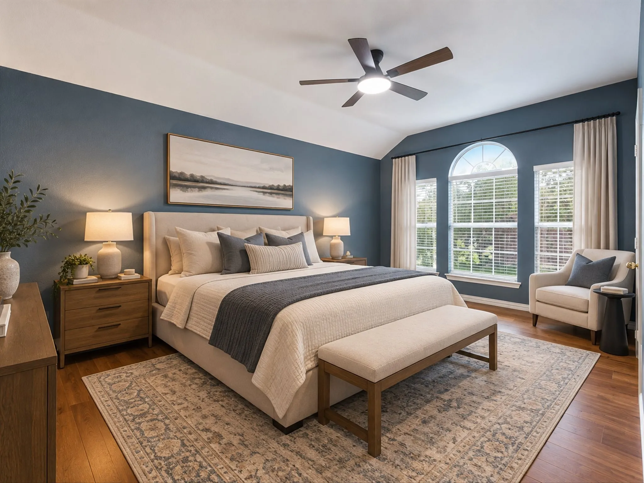 Vaulted ceiling, wood-finish flooring, ceiling fan with integrated lighting, and arched window with blinds