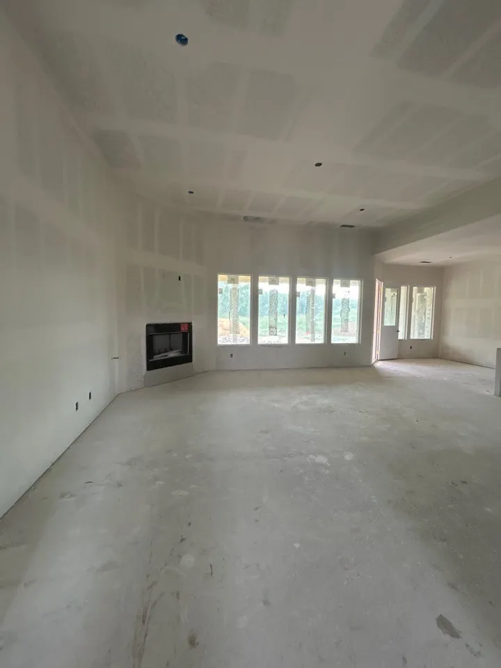 Expansive interior space featuring a corner fireplace, multiple windows, and recessed lighting