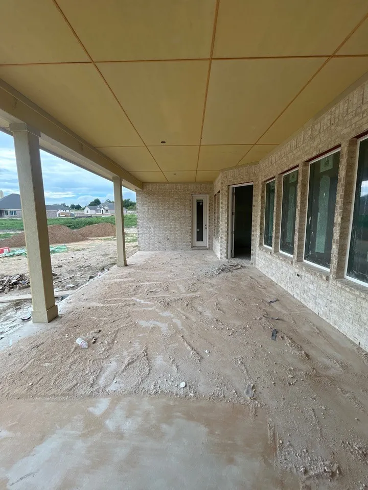 Expansive covered patio with support columns and a finished ceiling