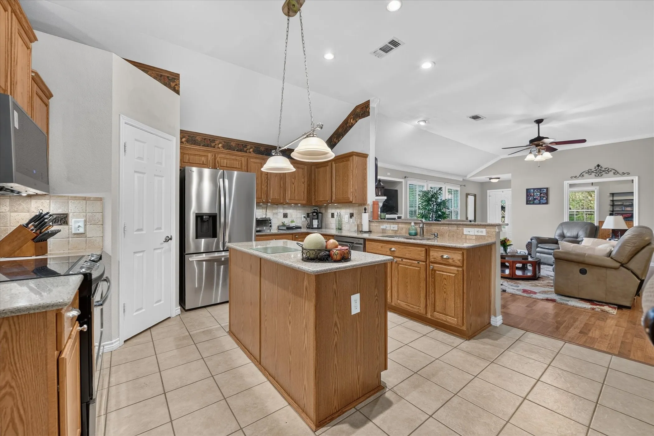 Kitchen featuring wood-finish cabinetry, tile flooring, and a center island