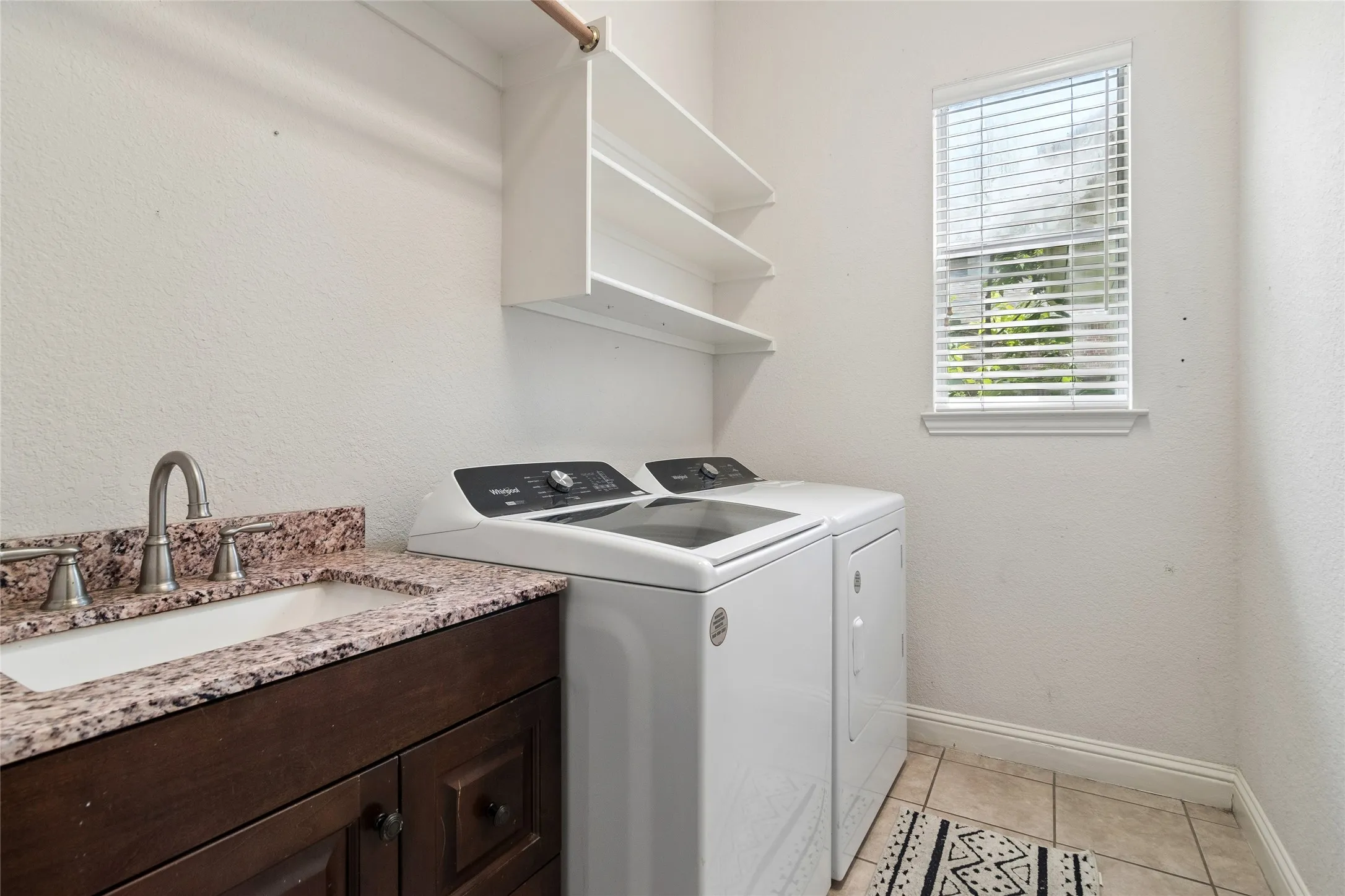 Separate utility room with sink, shelving and drying area