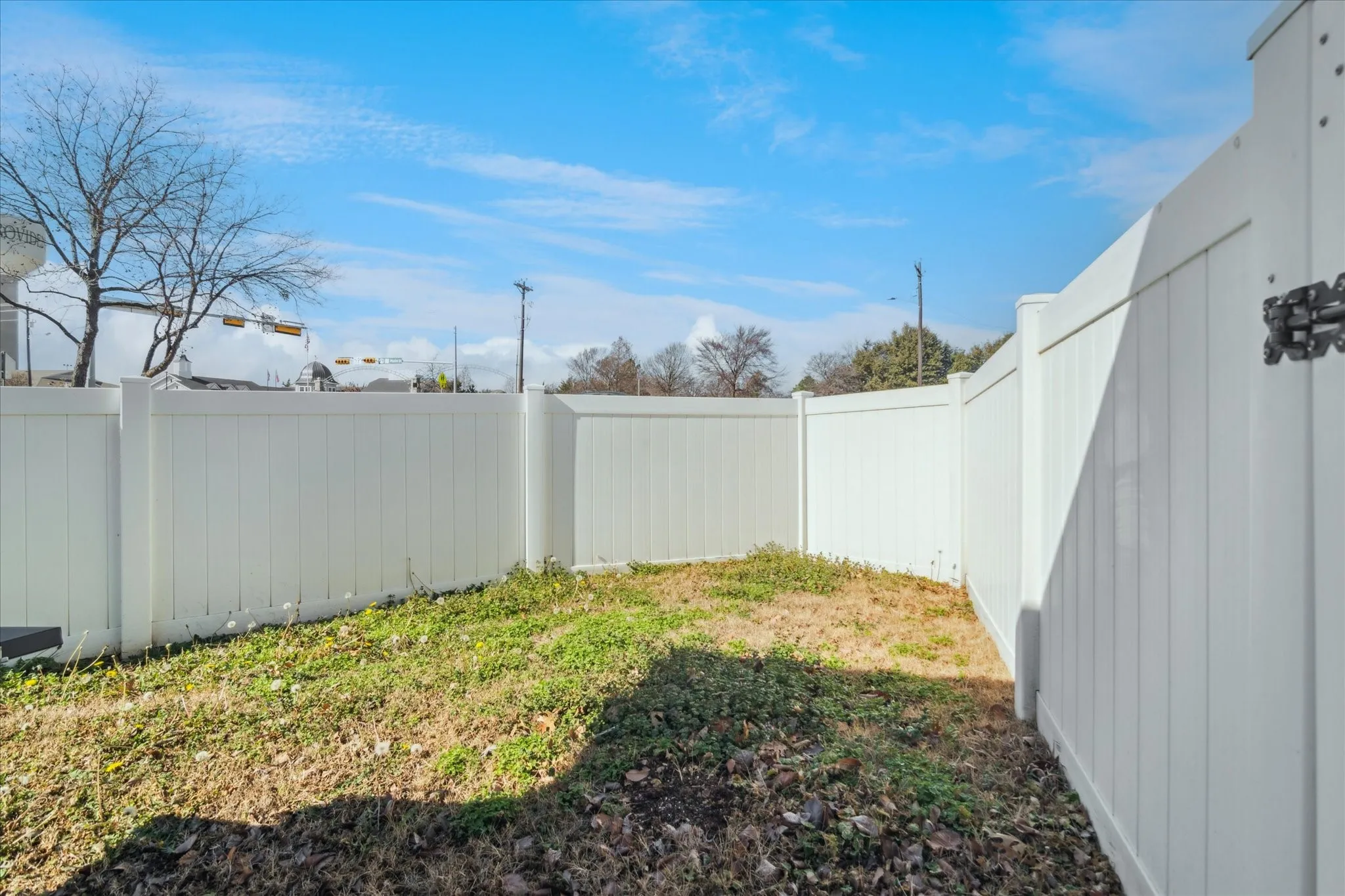 Enclosed yard with a white panel fence