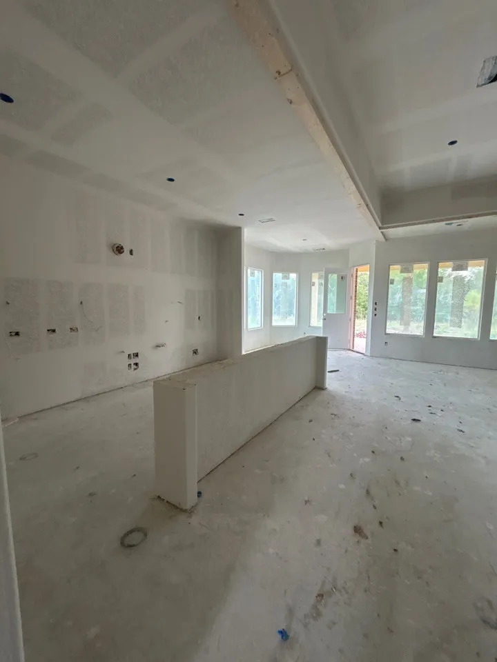 Recessed lighting installations, multiple windows providing natural illumination, and a built-in gypsum divider