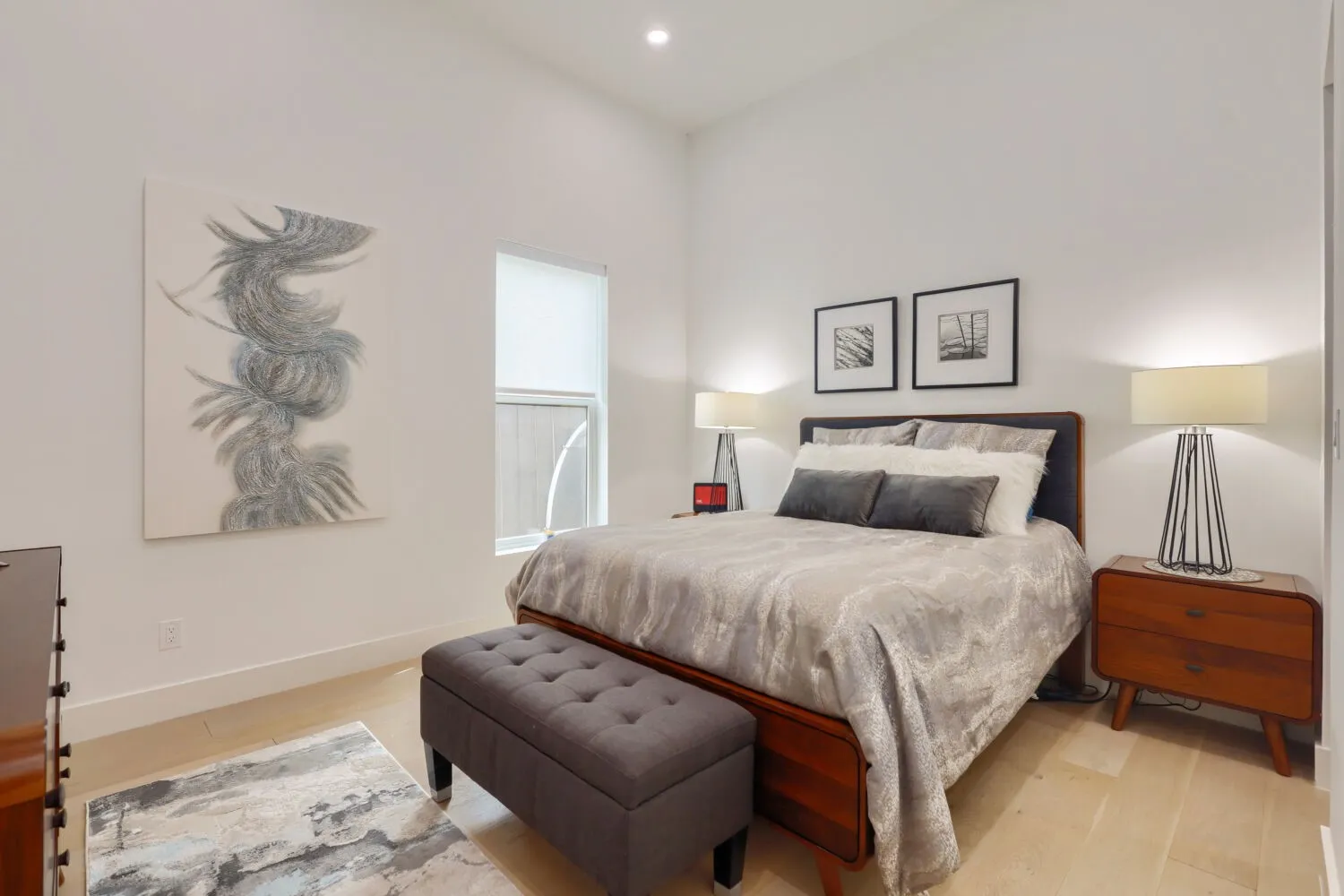 Floor 1 Vaulted ceiling, recessed lighting, light wood-finish flooring, and a single window with a roller shade