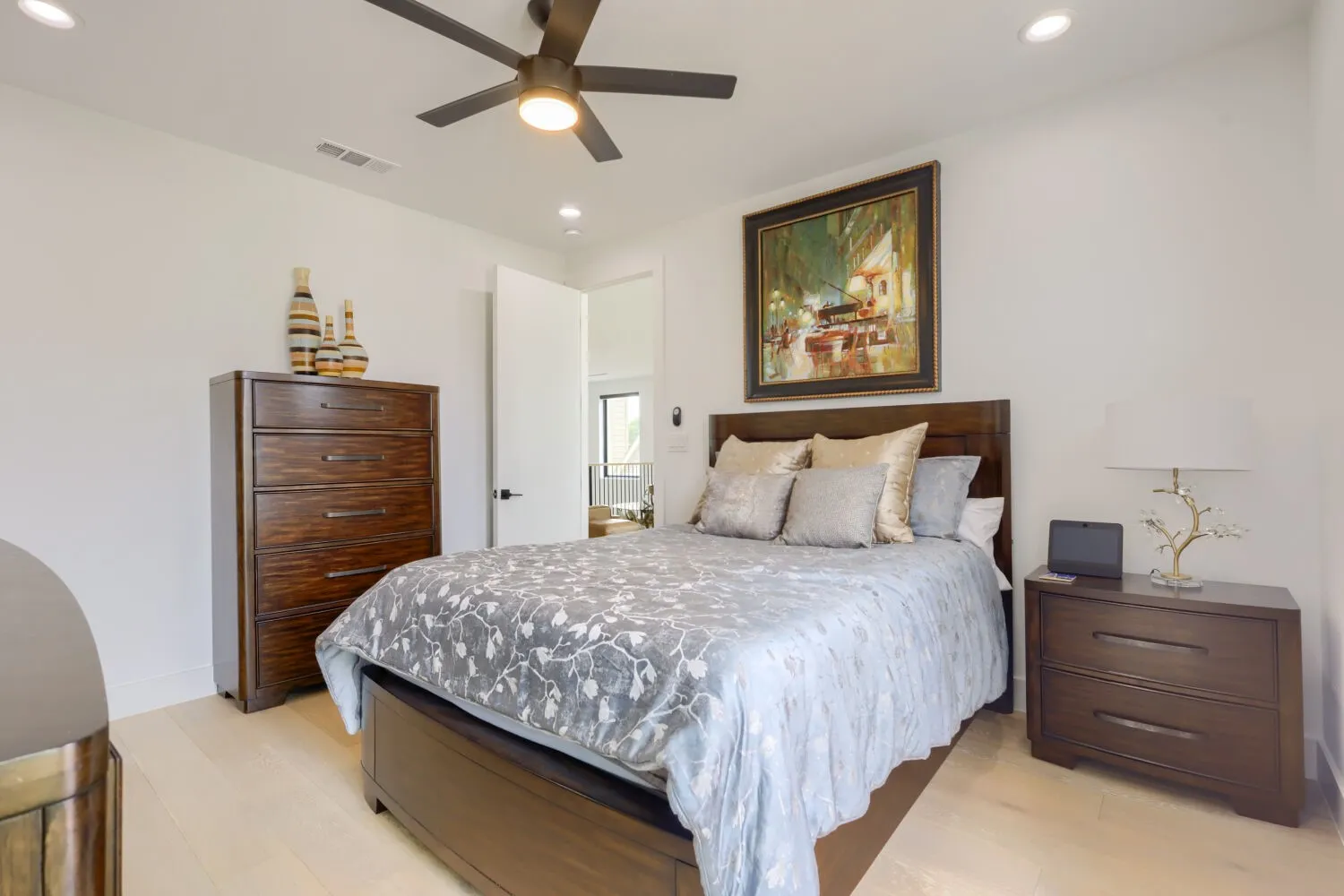 Wood-finish flooring, recessed lighting, and a ceiling fan with integrated lighting