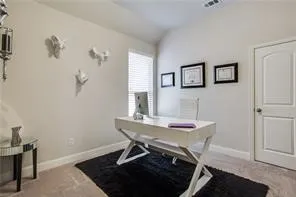 Vaulted ceiling, light-colored walls, carpeted flooring, window with blinds, and paneled door