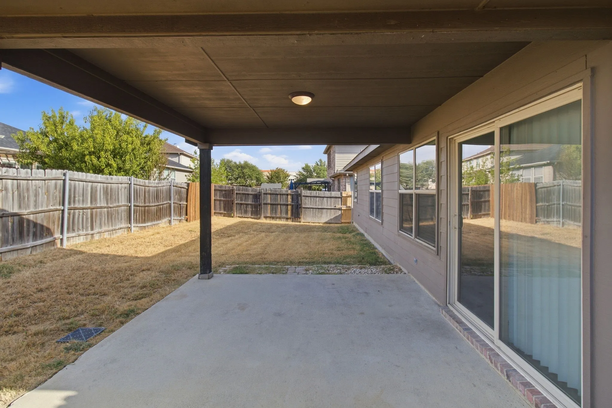 Covered patio with concrete flooring, recessed lighting, and a sliding glass door