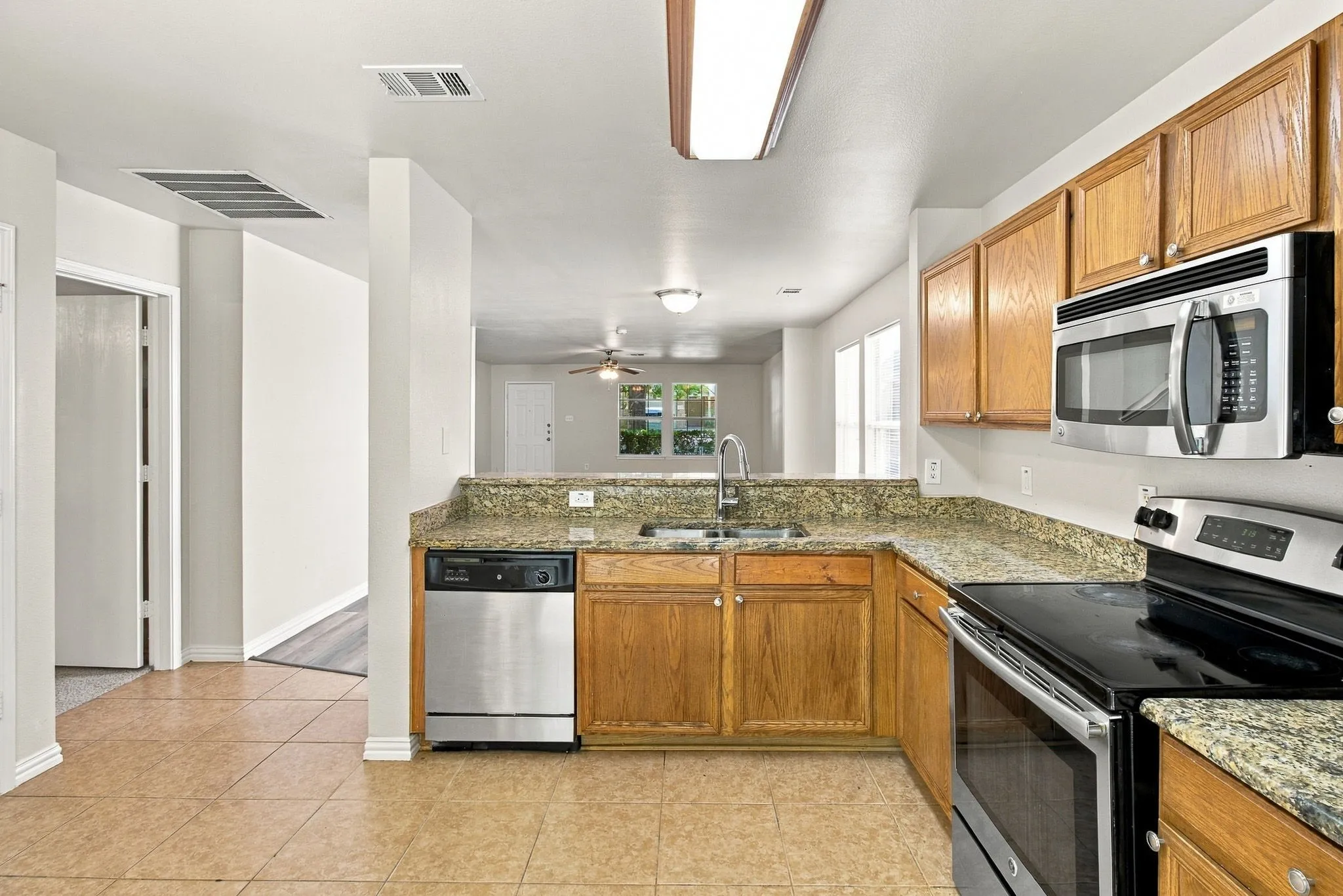 Kitchen featuring a stainless steel dishwasher, built-in microwave, and oven with stovetop