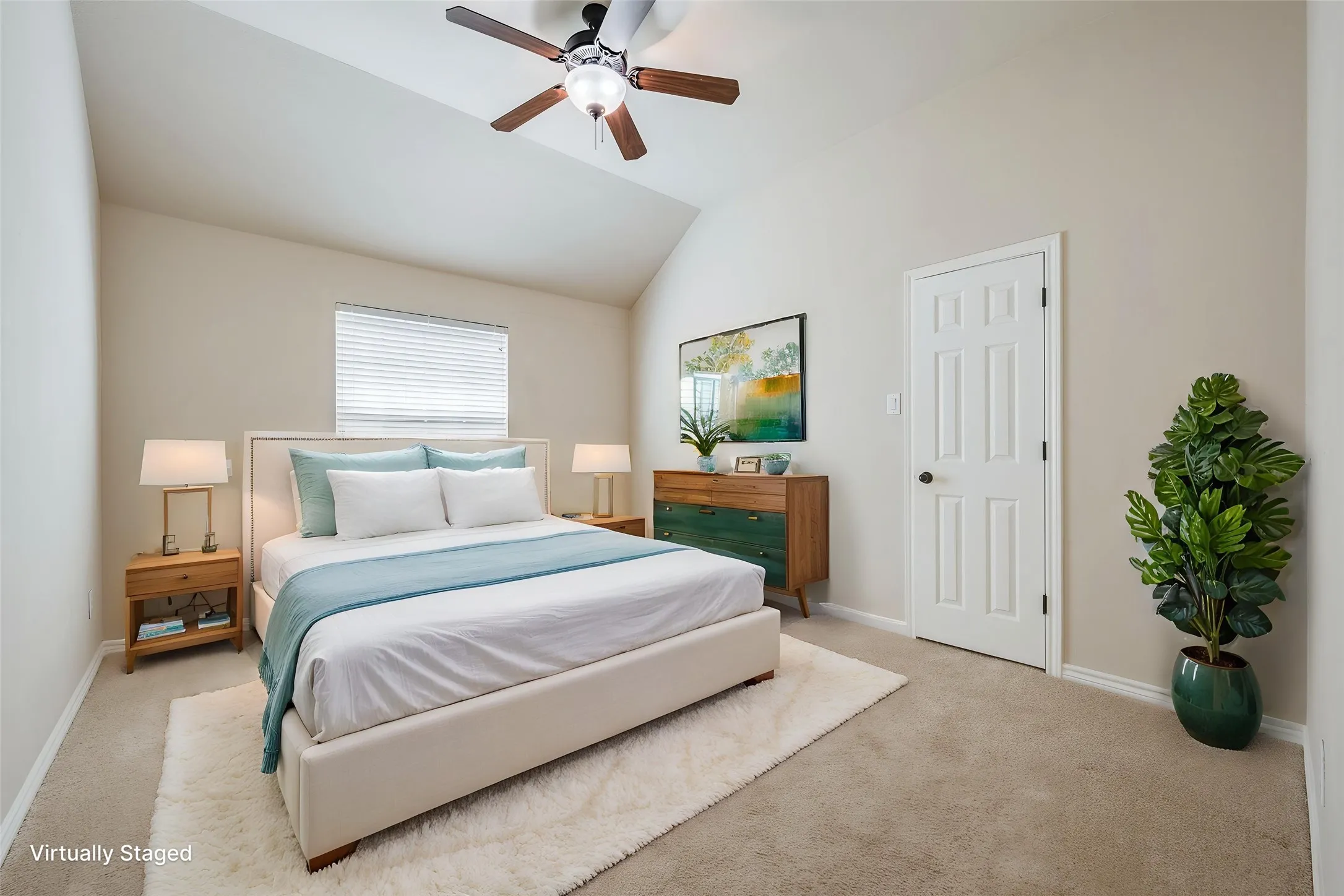 Vaulted ceiling, ceiling fan with light fixture, window with blinds, paneled interior door, and carpeted flooring