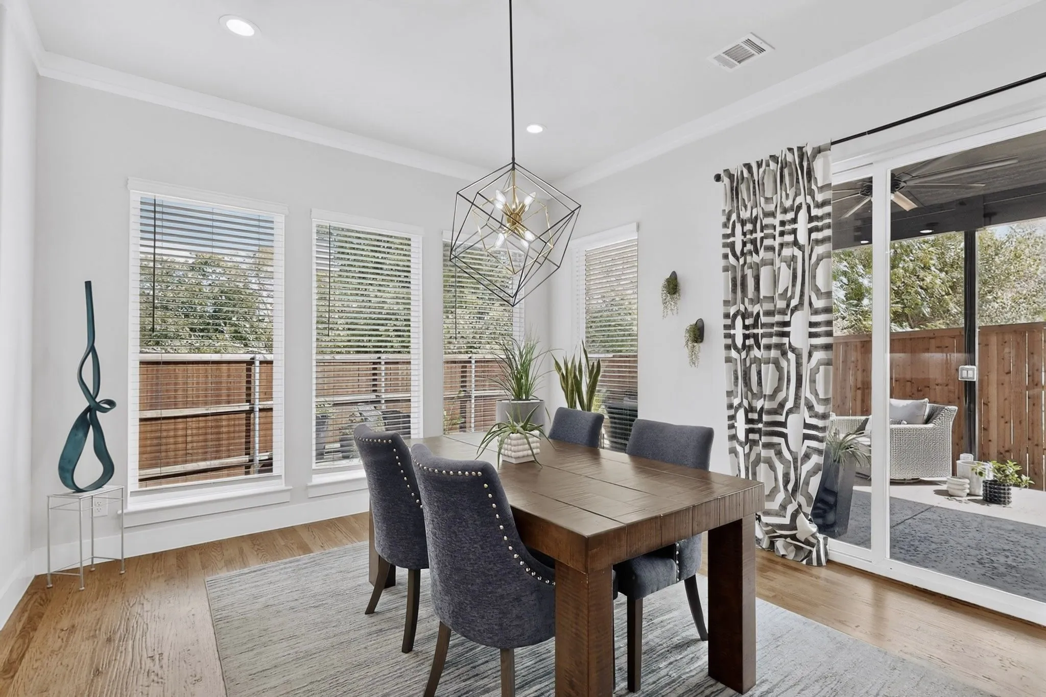 Recessed lighting, wood-finish flooring, and multiple windows with blinds