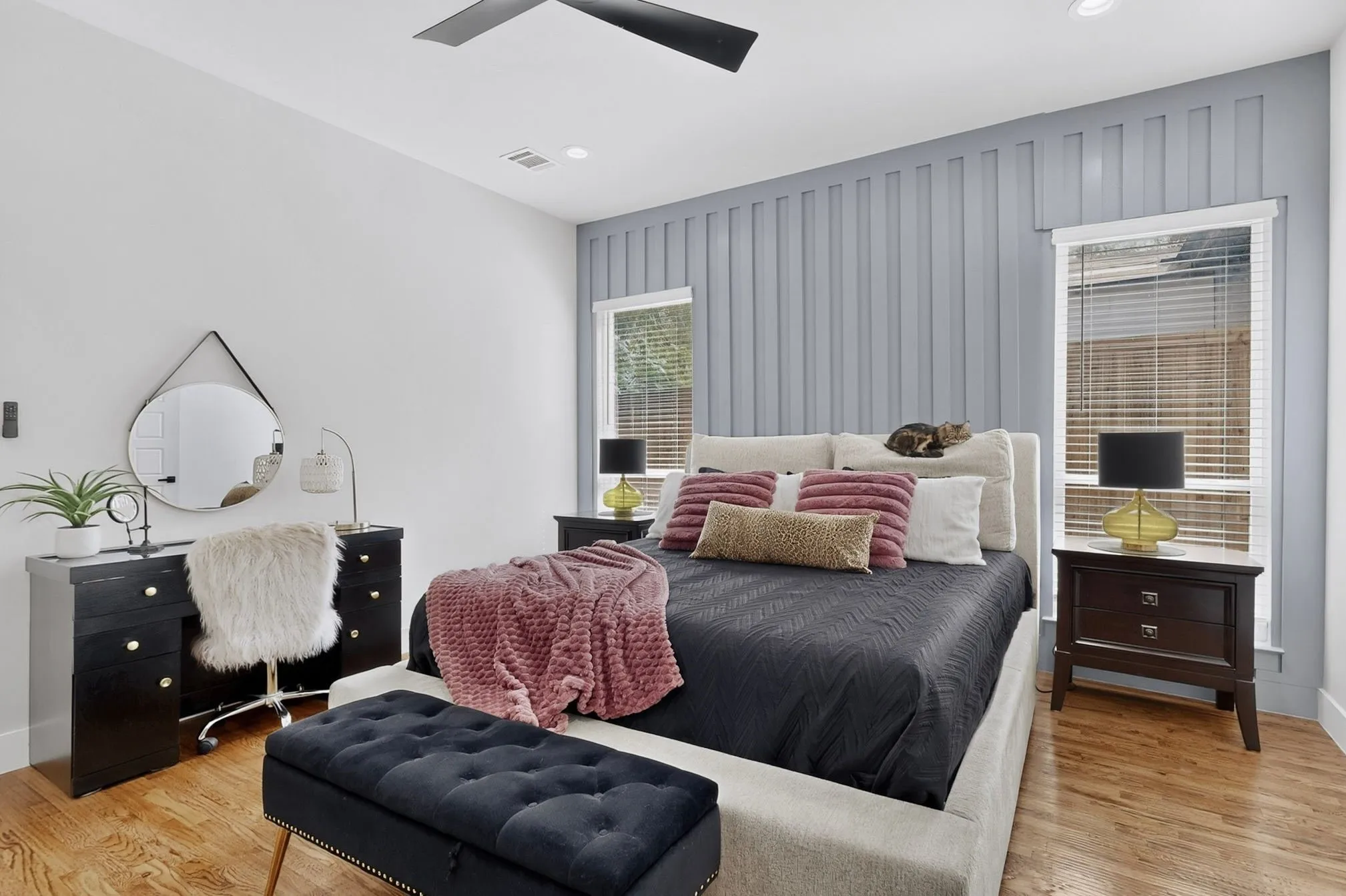 Hardwood-finish flooring, accent wall with vertical paneling, recessed lighting, and ceiling fan