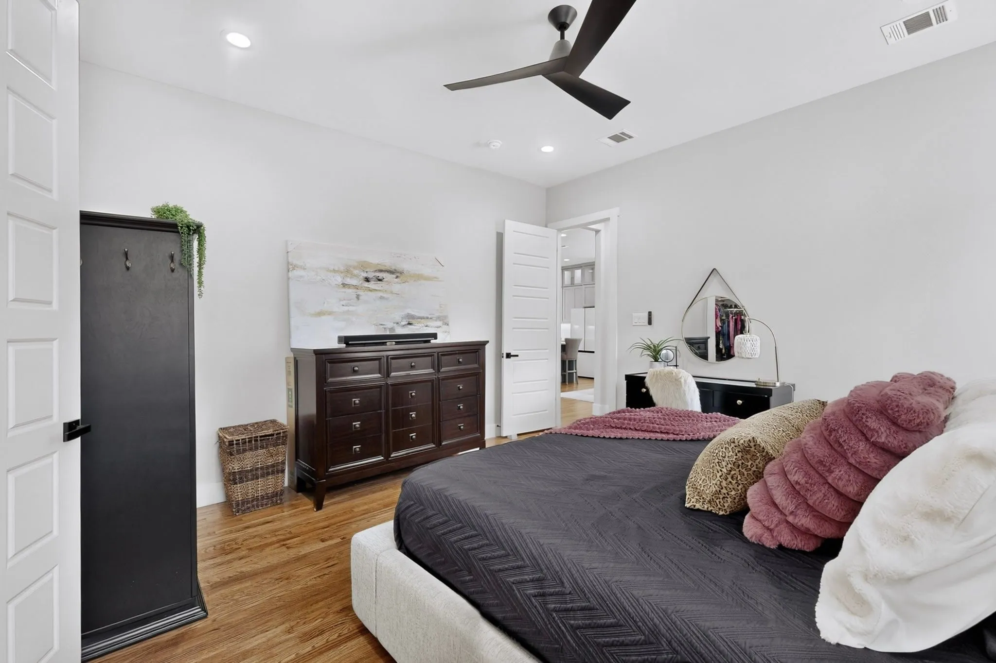 Wood-finish flooring, recessed lighting, and a contemporary ceiling fan