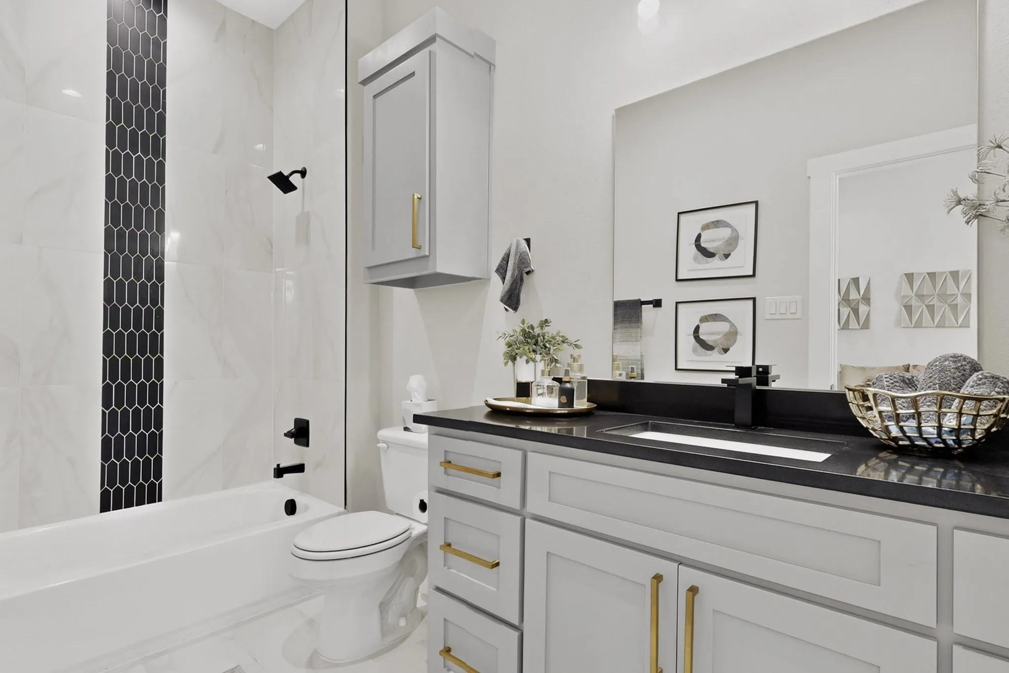 White bathtub with black matte fixtures and a black picket tile accent