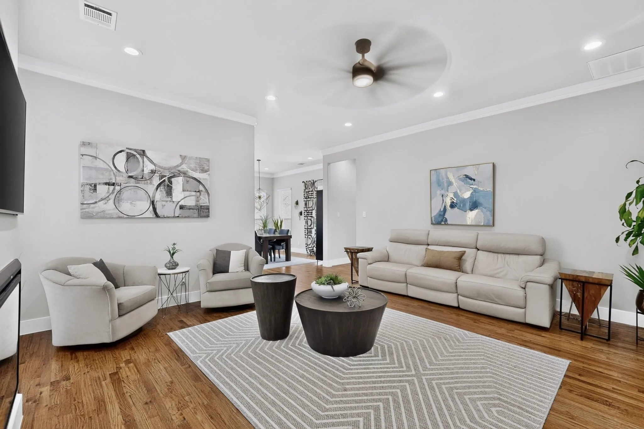 Wood-finish flooring, recessed lighting, crown molding, and ceiling fan
