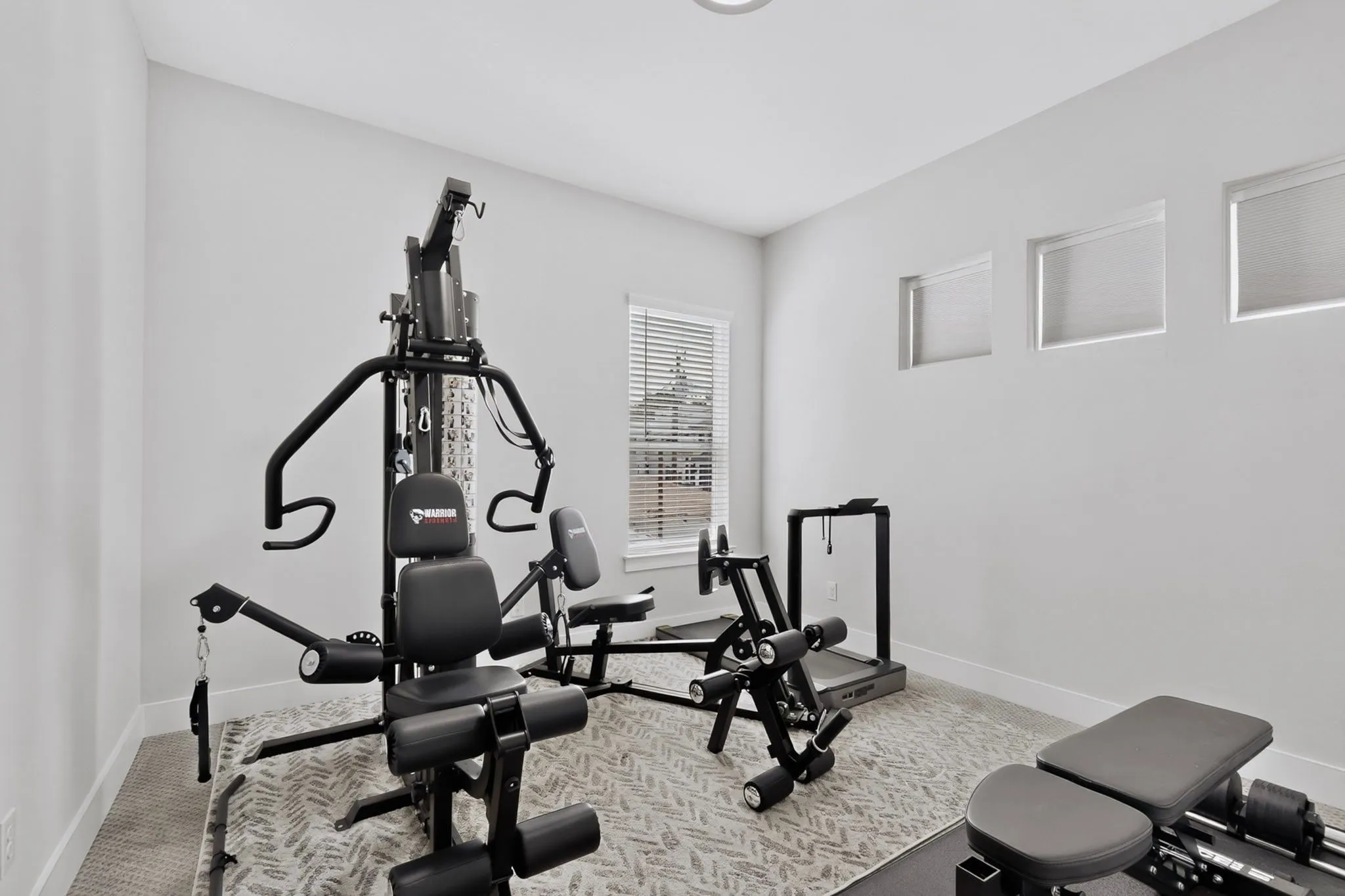 Recessed lighting, wall-to-wall carpeting, and a window with blinds