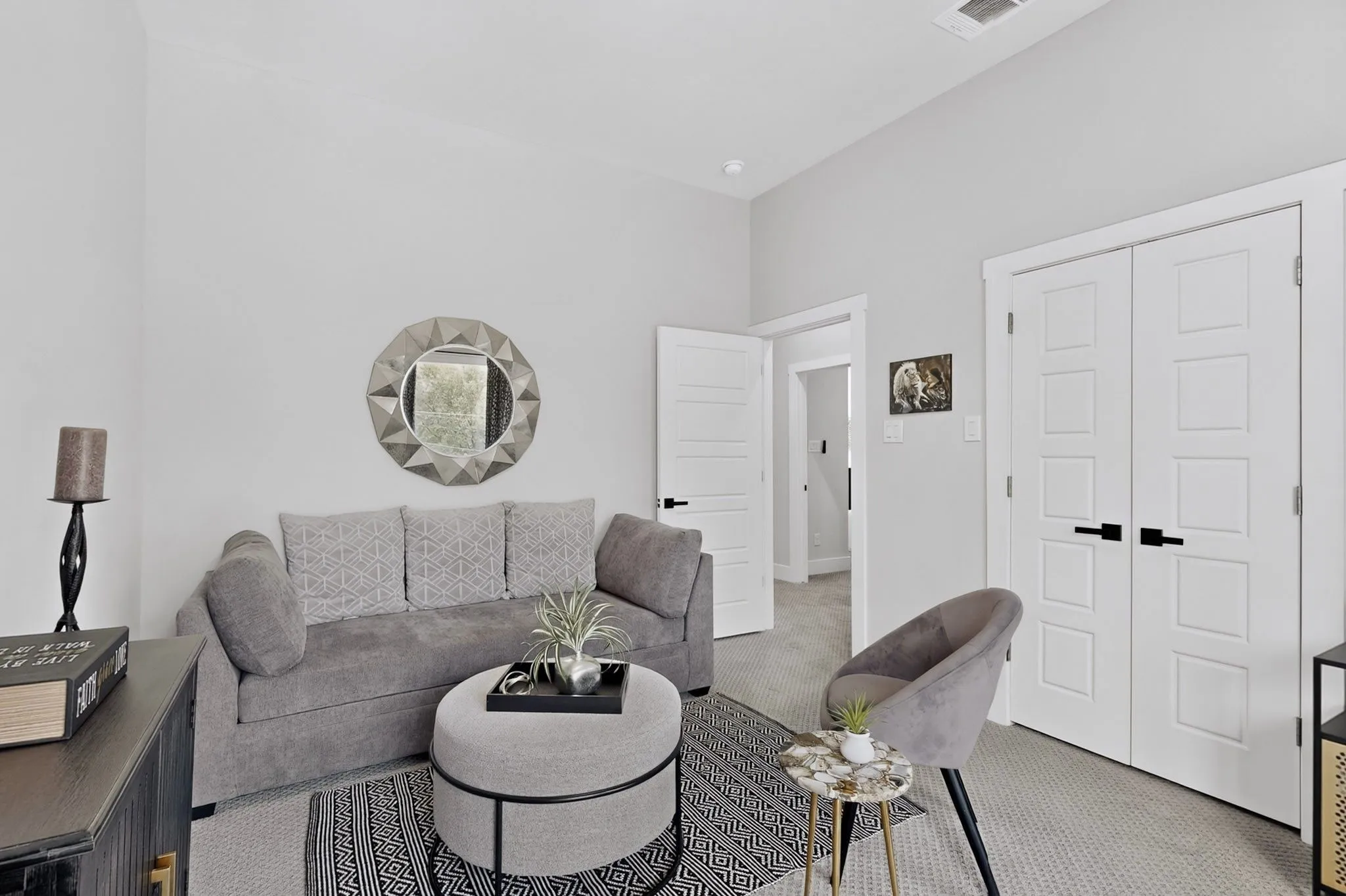 Neutral wall color, white trim, white paneled doors, carpet flooring, and recessed lighting
