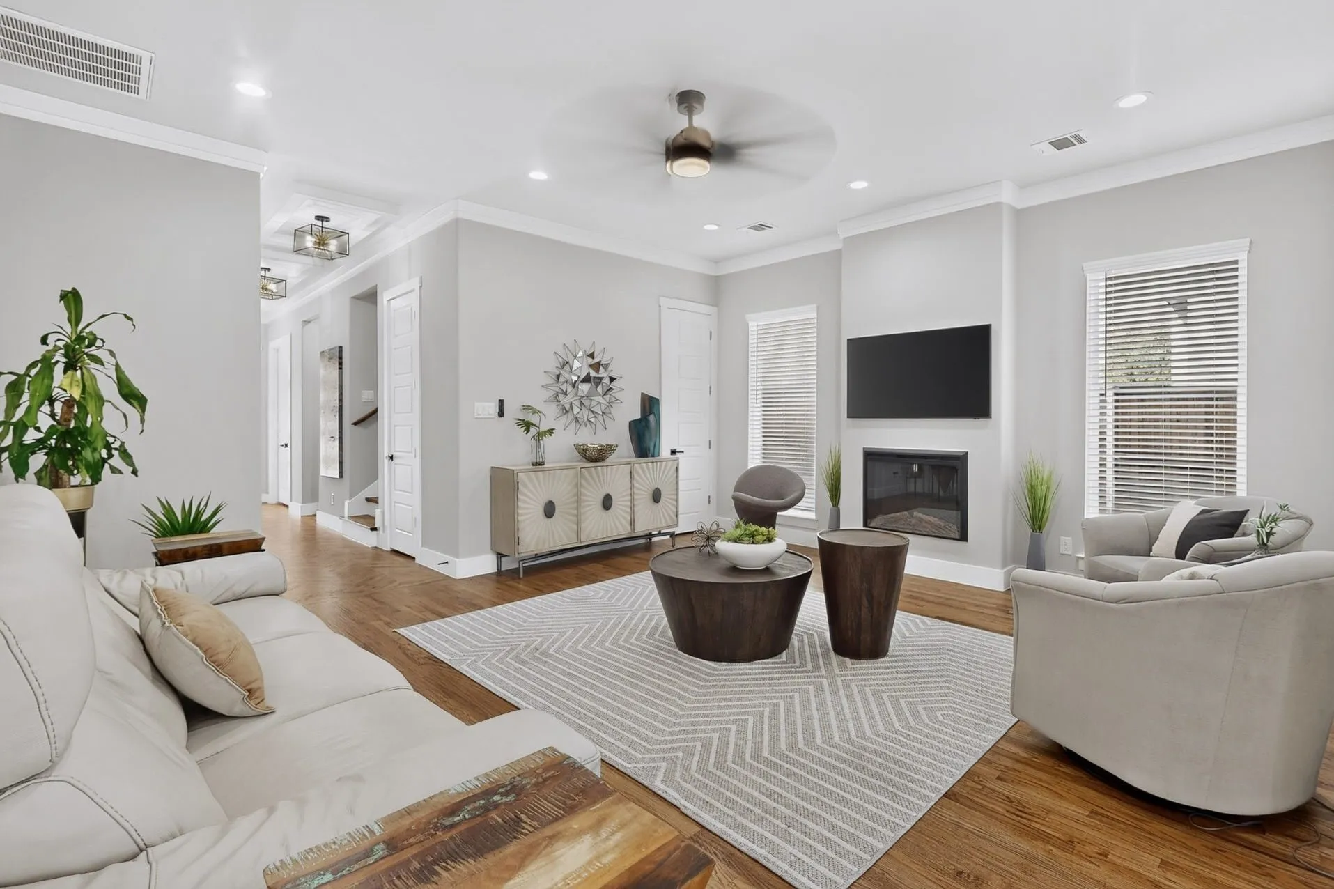 Hardwood flooring, recessed lighting, crown molding, modern ceiling fan, and built-in fireplace
