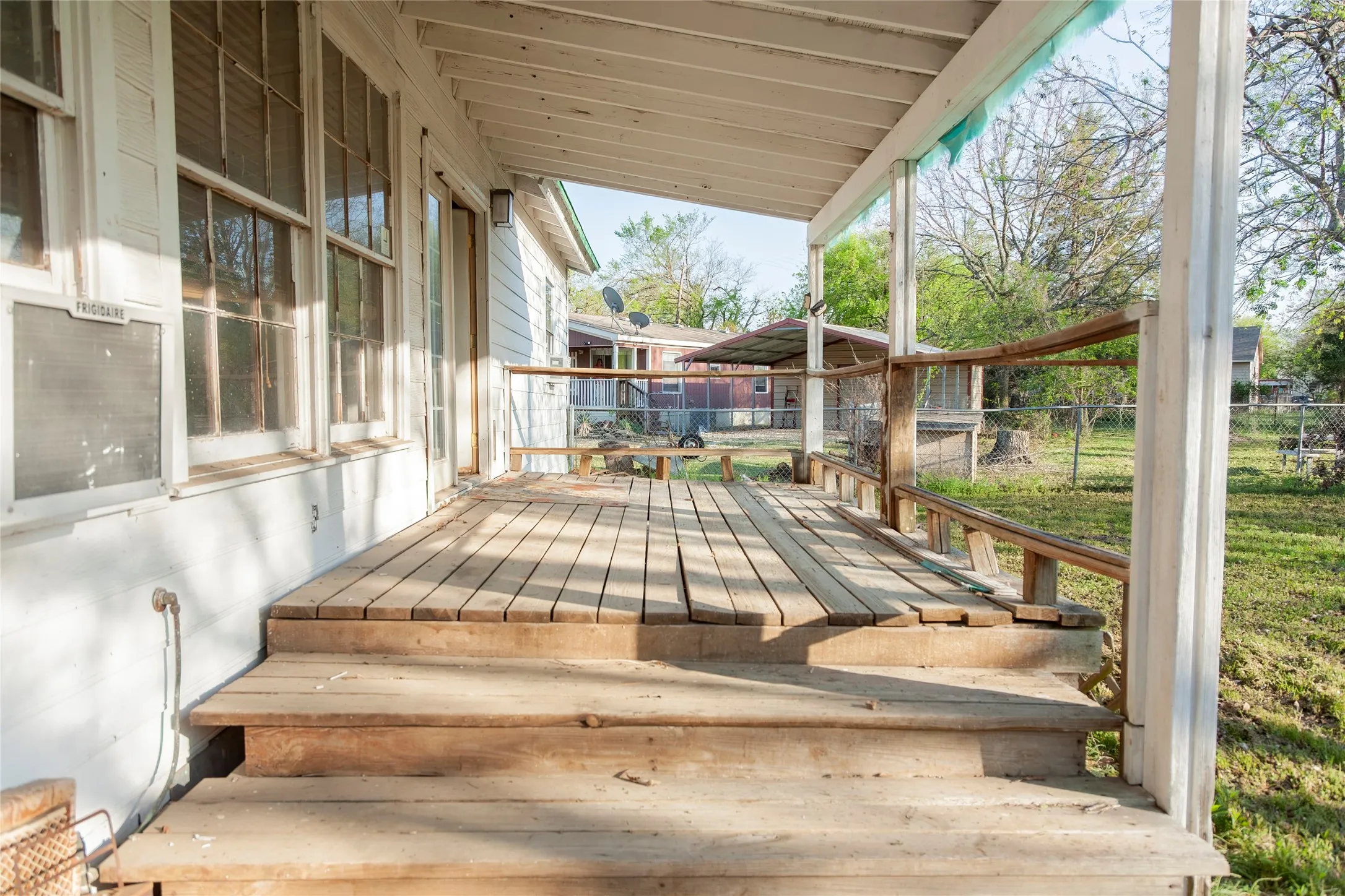 Wood-finish deck with steps and a wooden railing