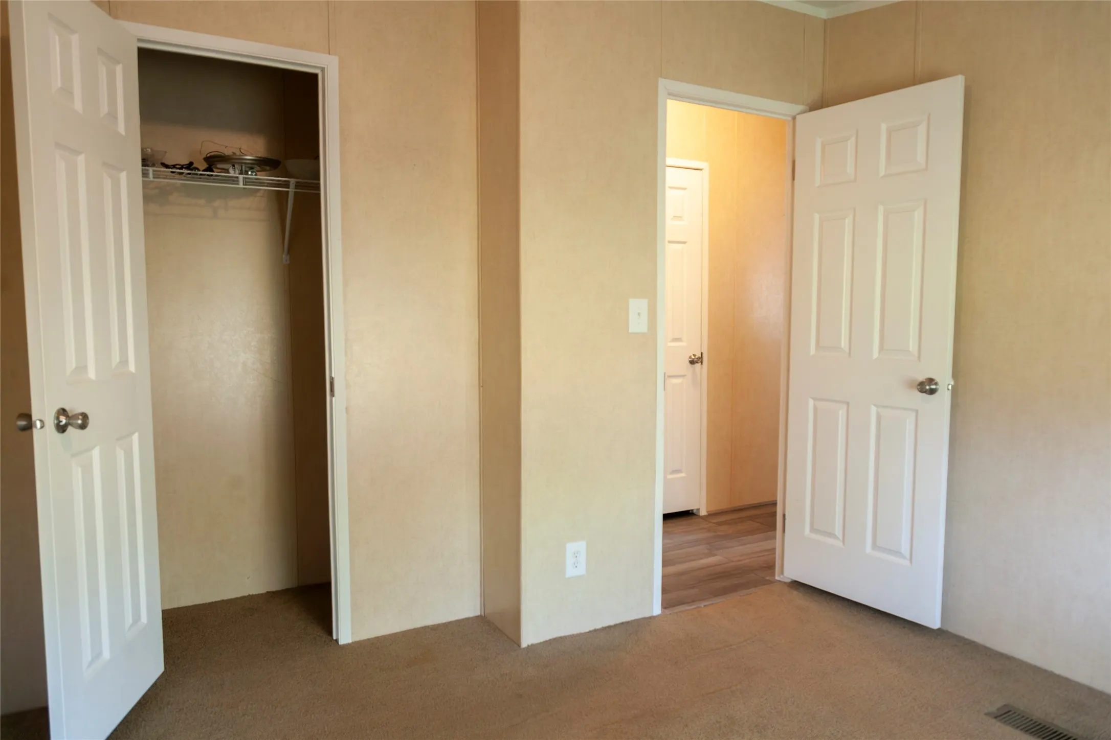 Interior space featuring paneled walls and carpet flooring