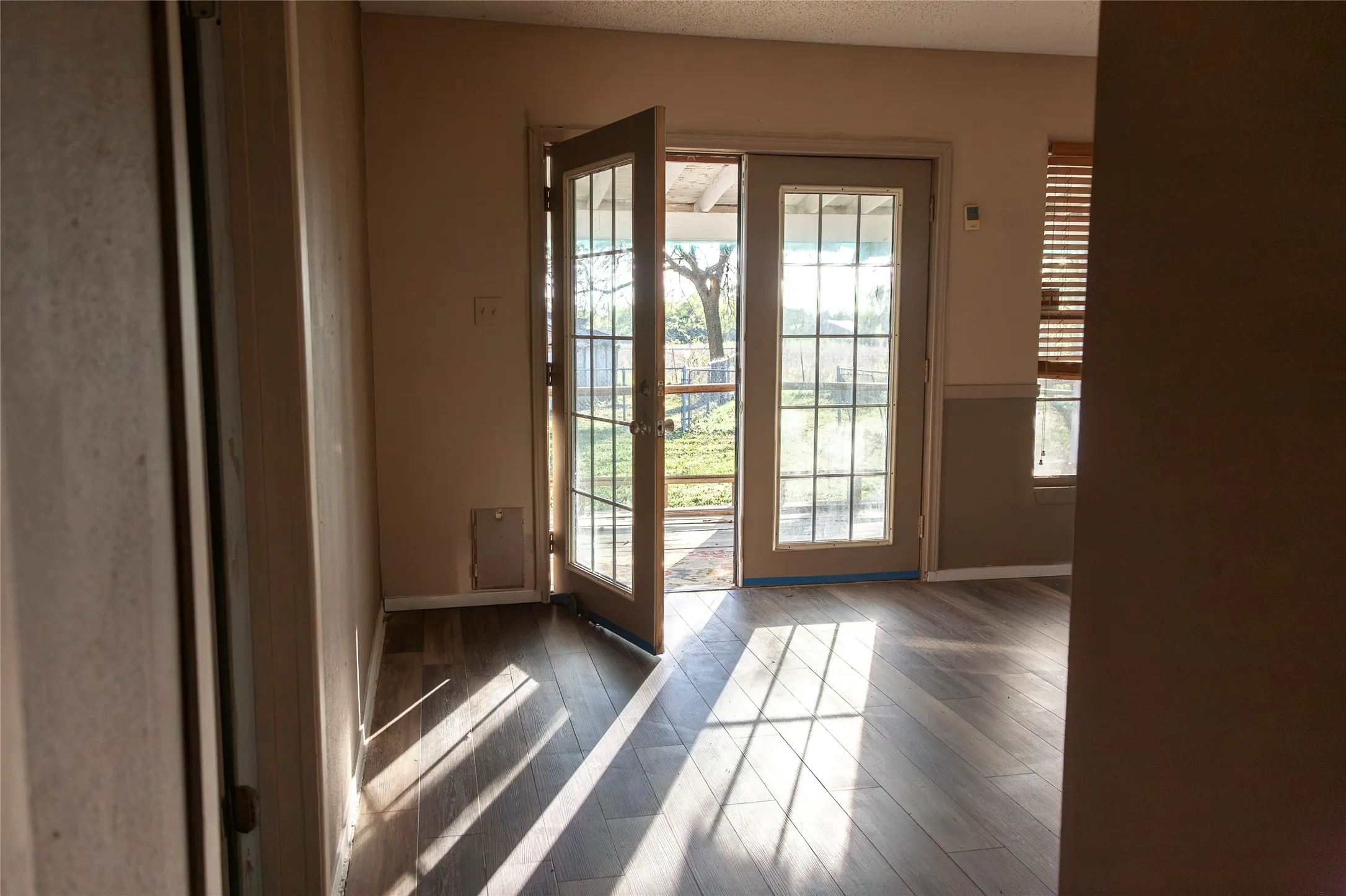 French doors with divided lites open to the exterior