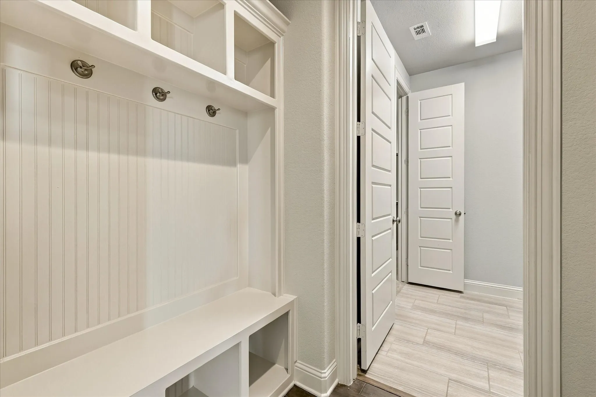 The mudroom with cubbies is just inside the garage entrance