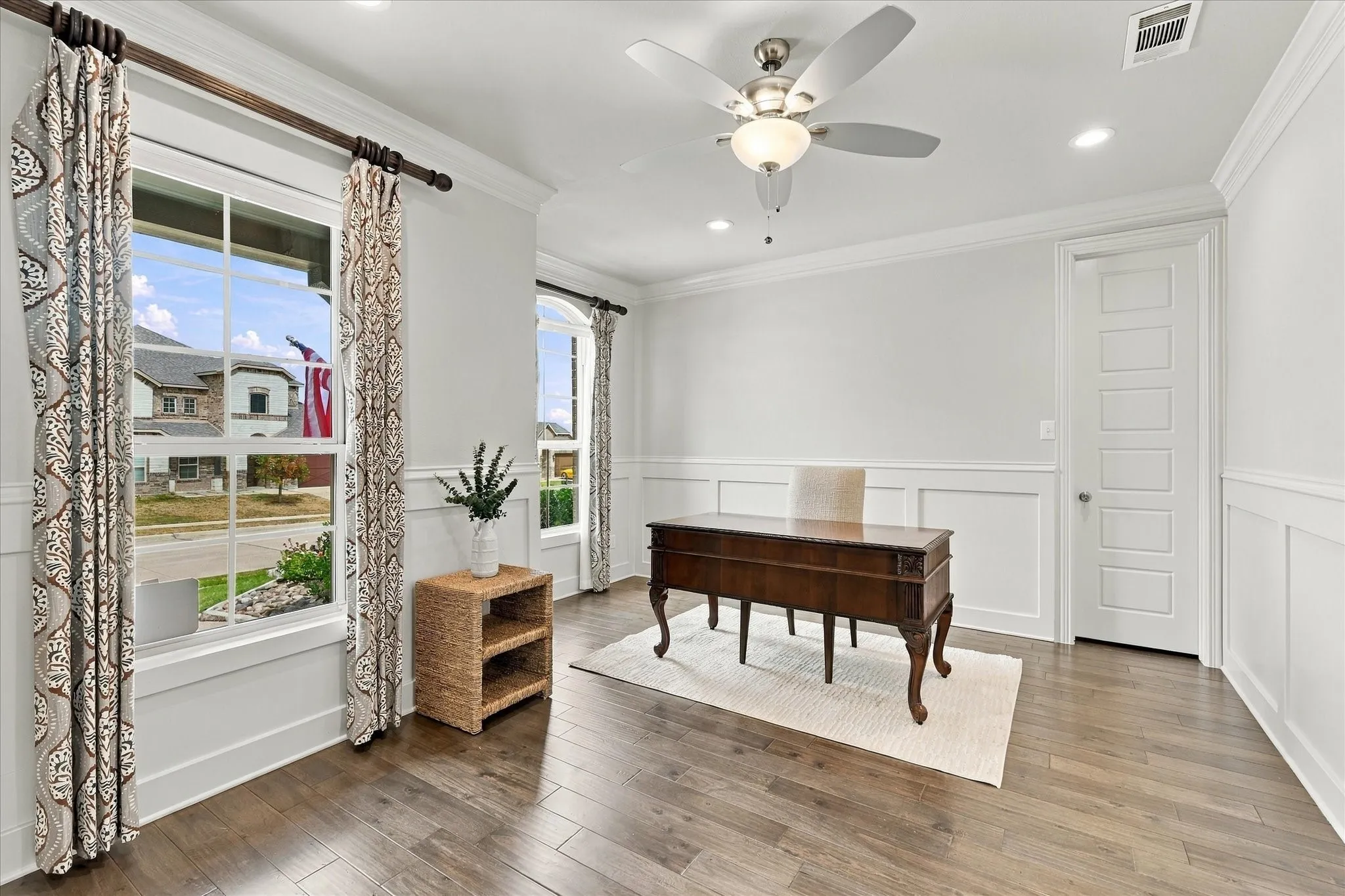 The large office has beautiful windows and a walk-in closet
